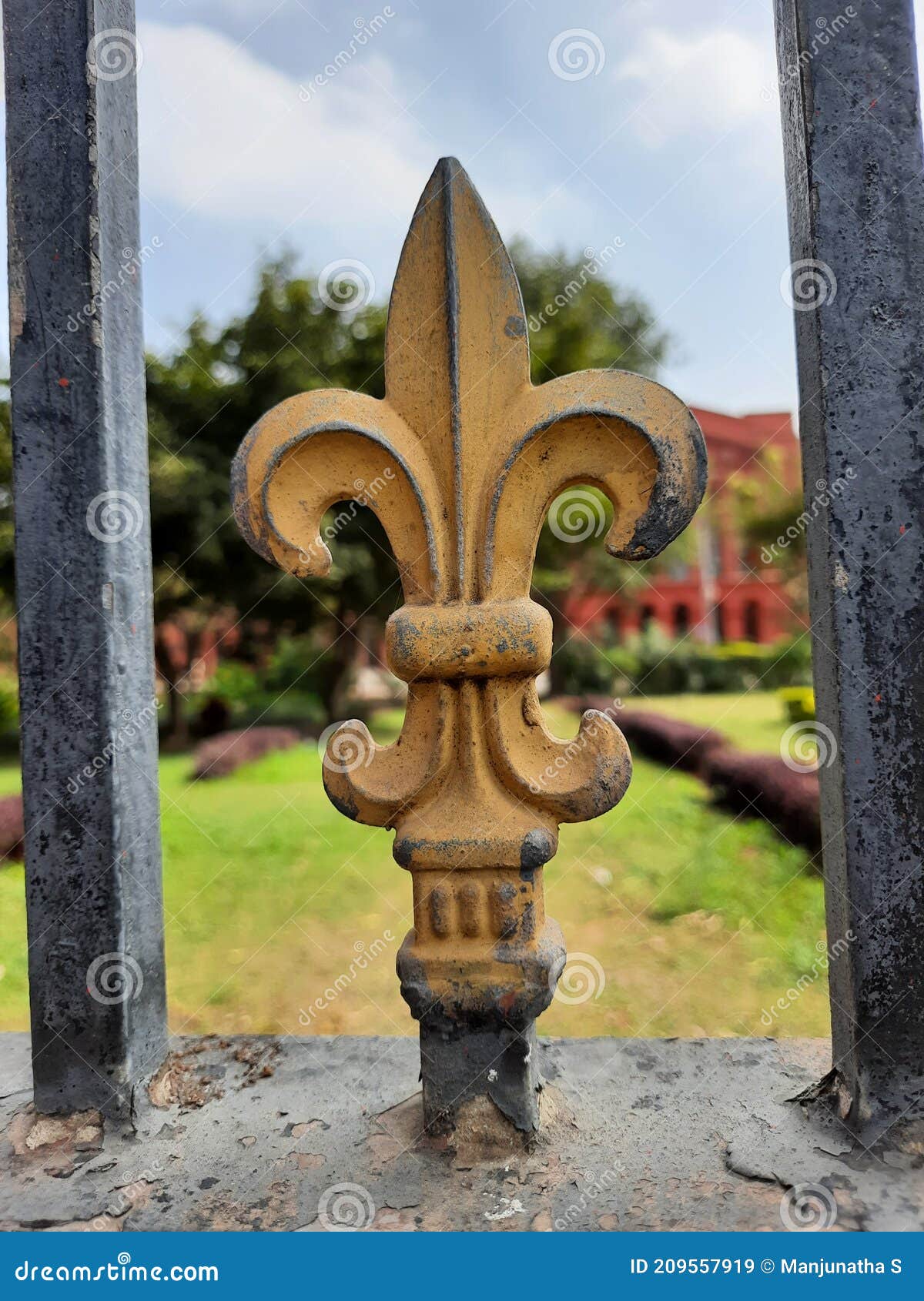 beautiful gold and black color iron gate railing like trident or flower   in a nature background