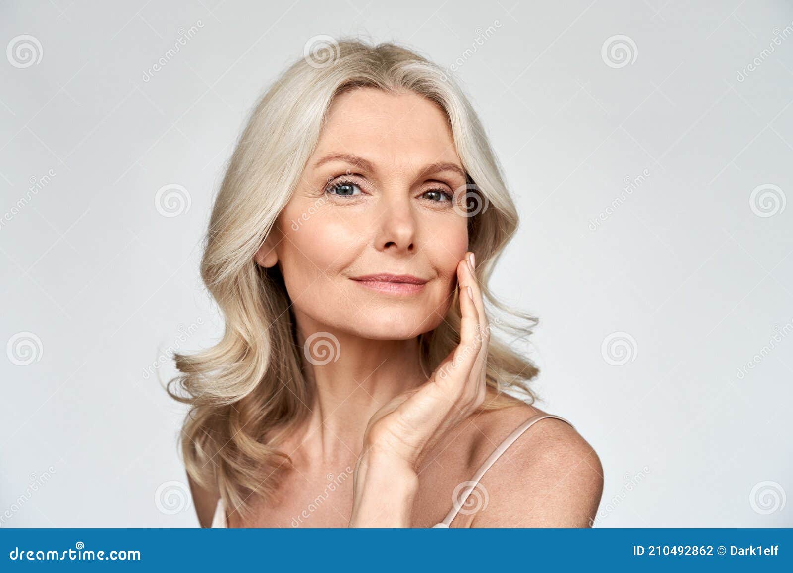 beautiful gorgeous mid aged mature woman looking at camera  on white.