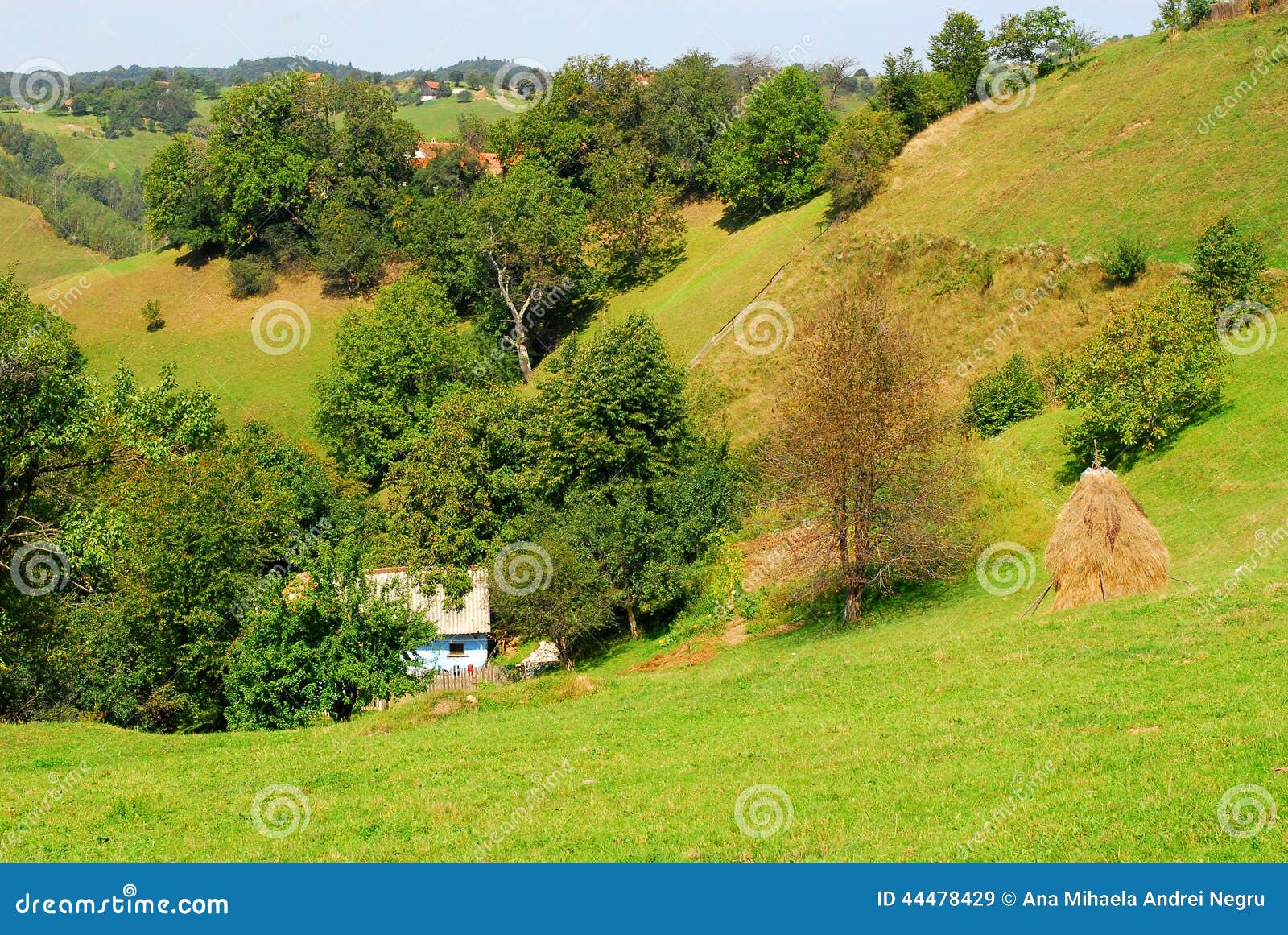 Beautiful green hills and small house at the countryside. Beautiful scenery with green hills, a hay stack and a small traditional house with no electricity at the countryside