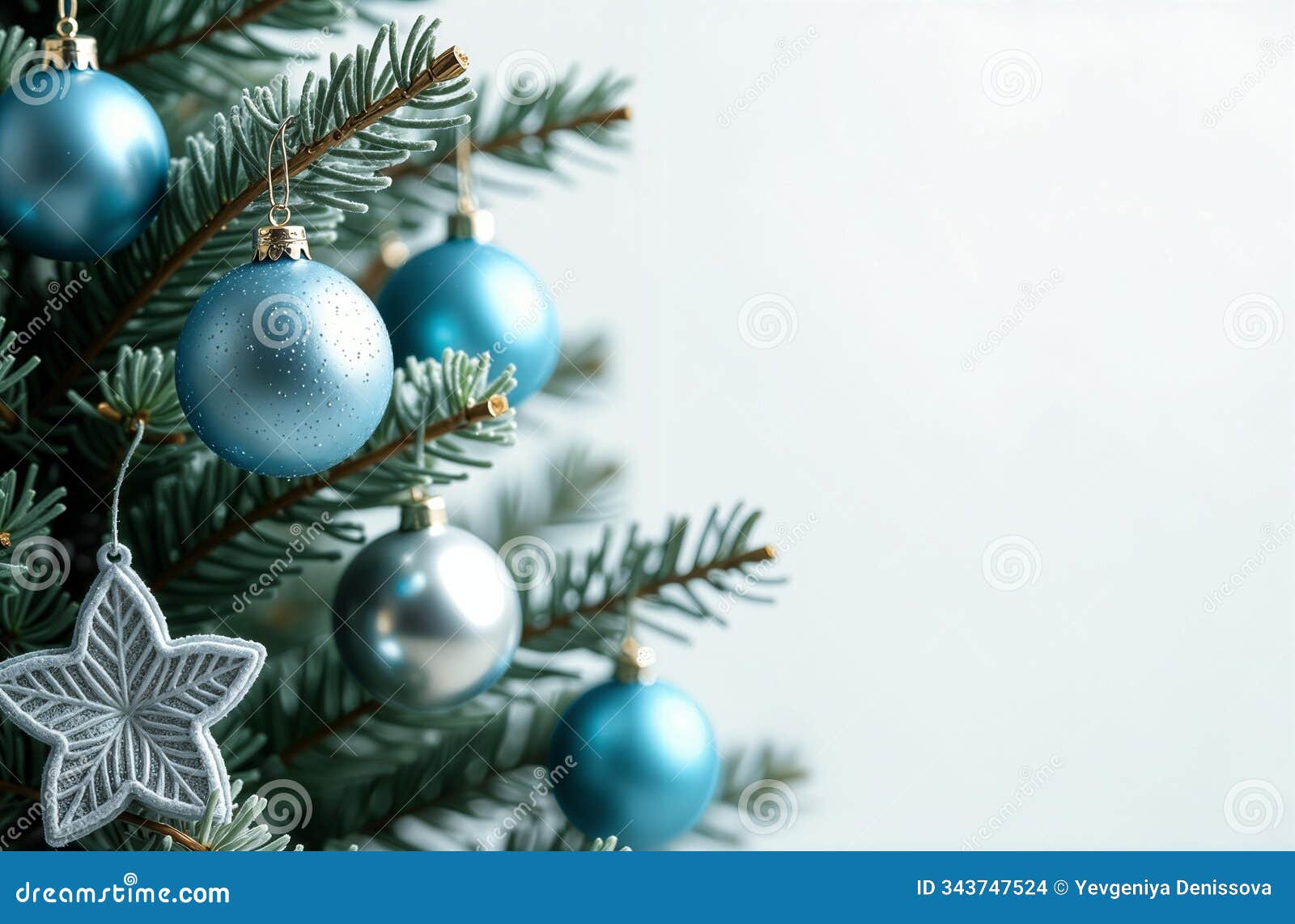 beautiful green new year's tree branches with blue and silver new year's toys