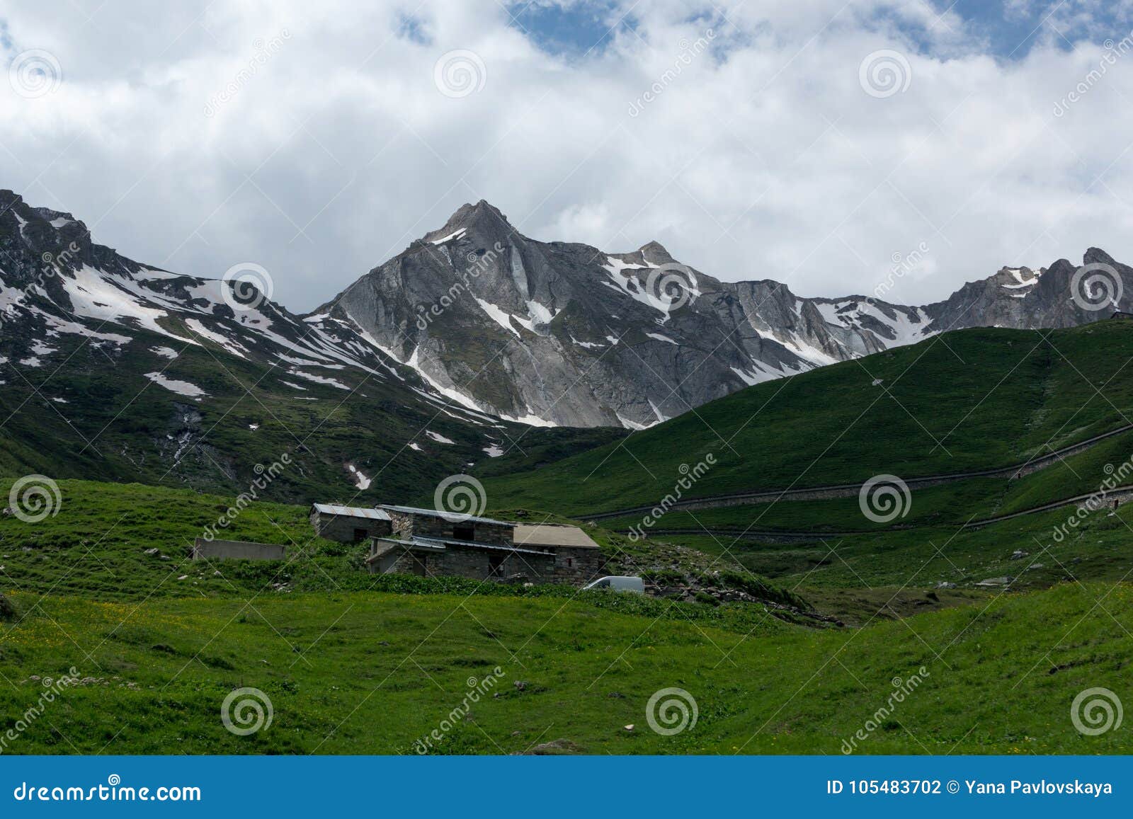 Beautiful Green Valley With Covered Snow Mountain Peaks Stock Photo