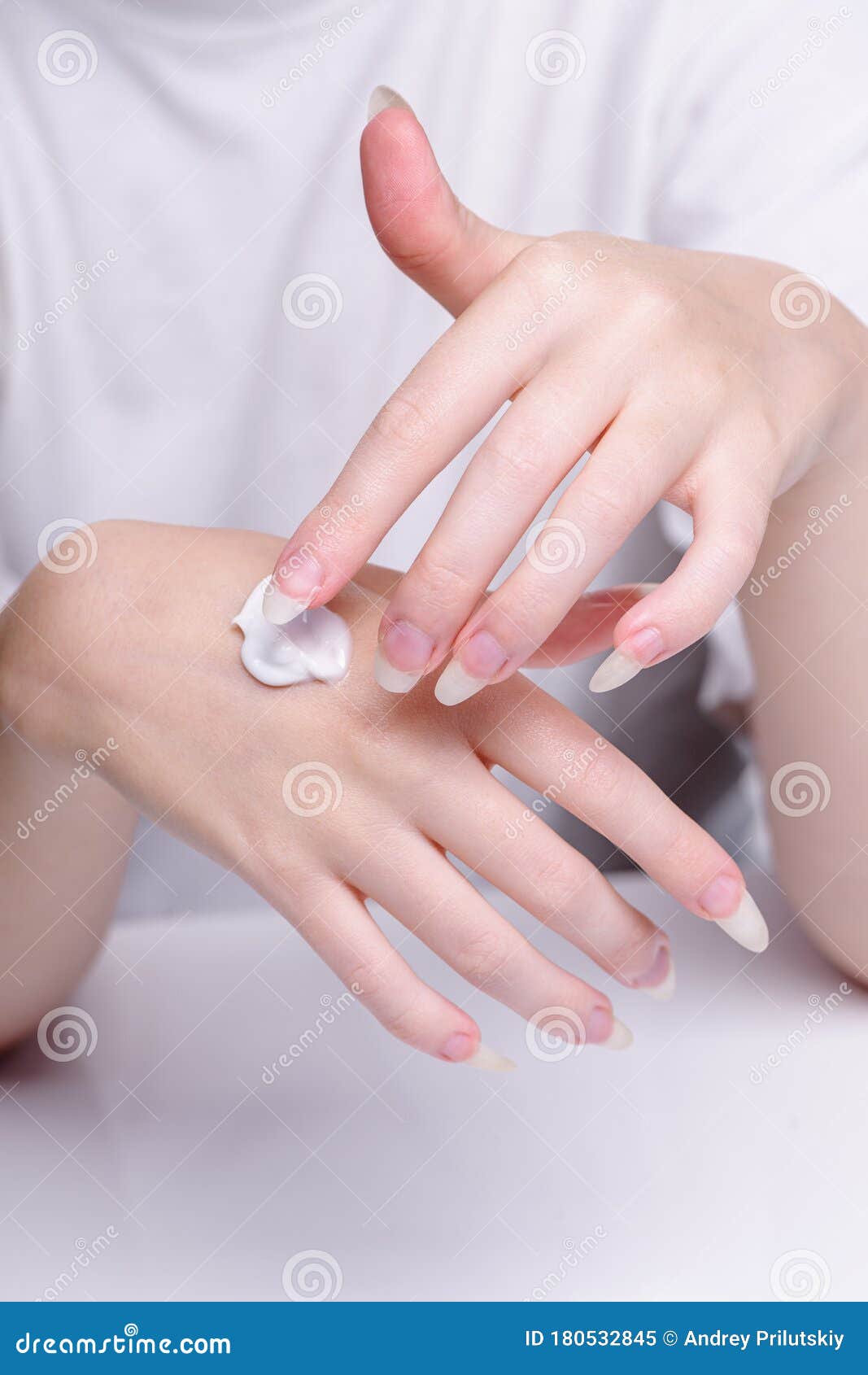 Beautiful Hands of Young Woman White Background. Applying ...