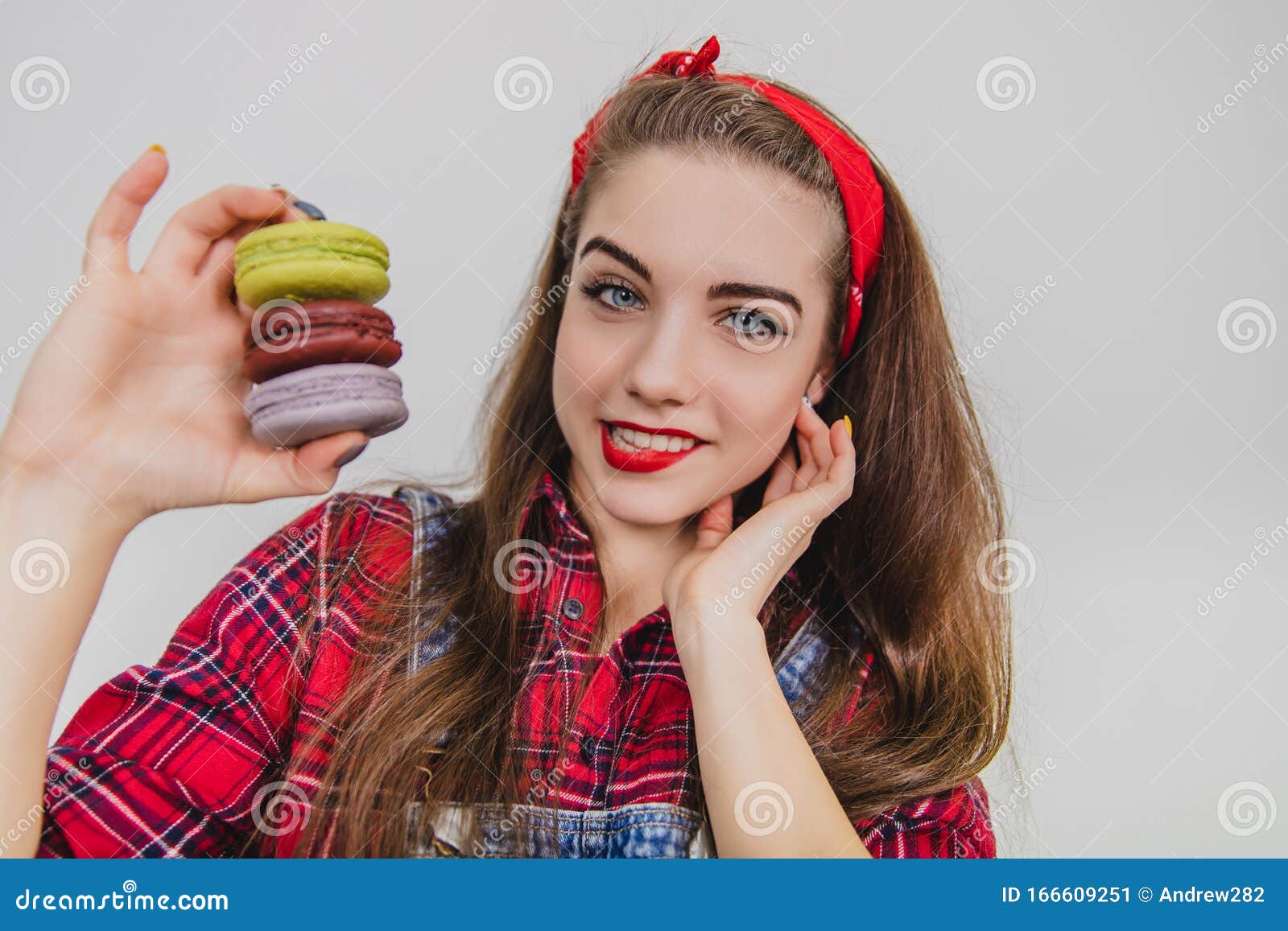 Beautiful Happy Cute Young Pretty Woman Holding A Pyramid Of Macaroons Looking At The Camera