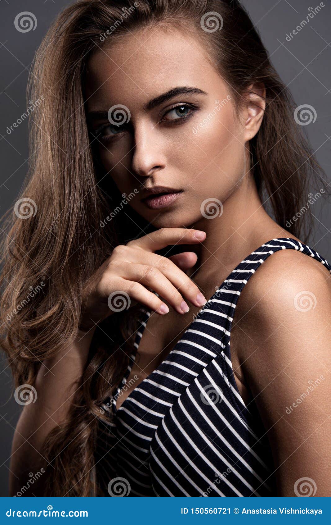 Beautiful Indian Woman with Nude Makeup and Long Brown Curly Hair Style,  Pink Lipstick Touching the Hand Her Healthy Skin on Brown Stock Image -  Image of eyebrow, makeup: 150560721