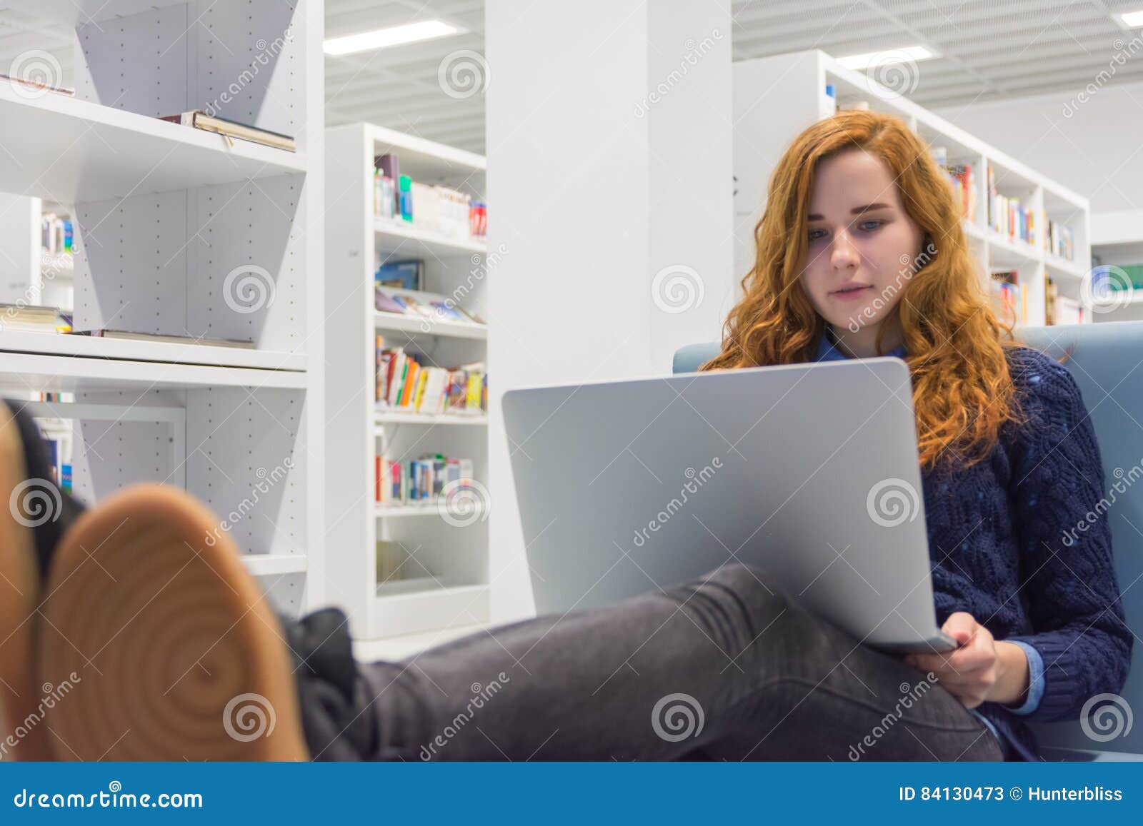 Beautiful Intelligent University Girl Using Laptop In White Mode