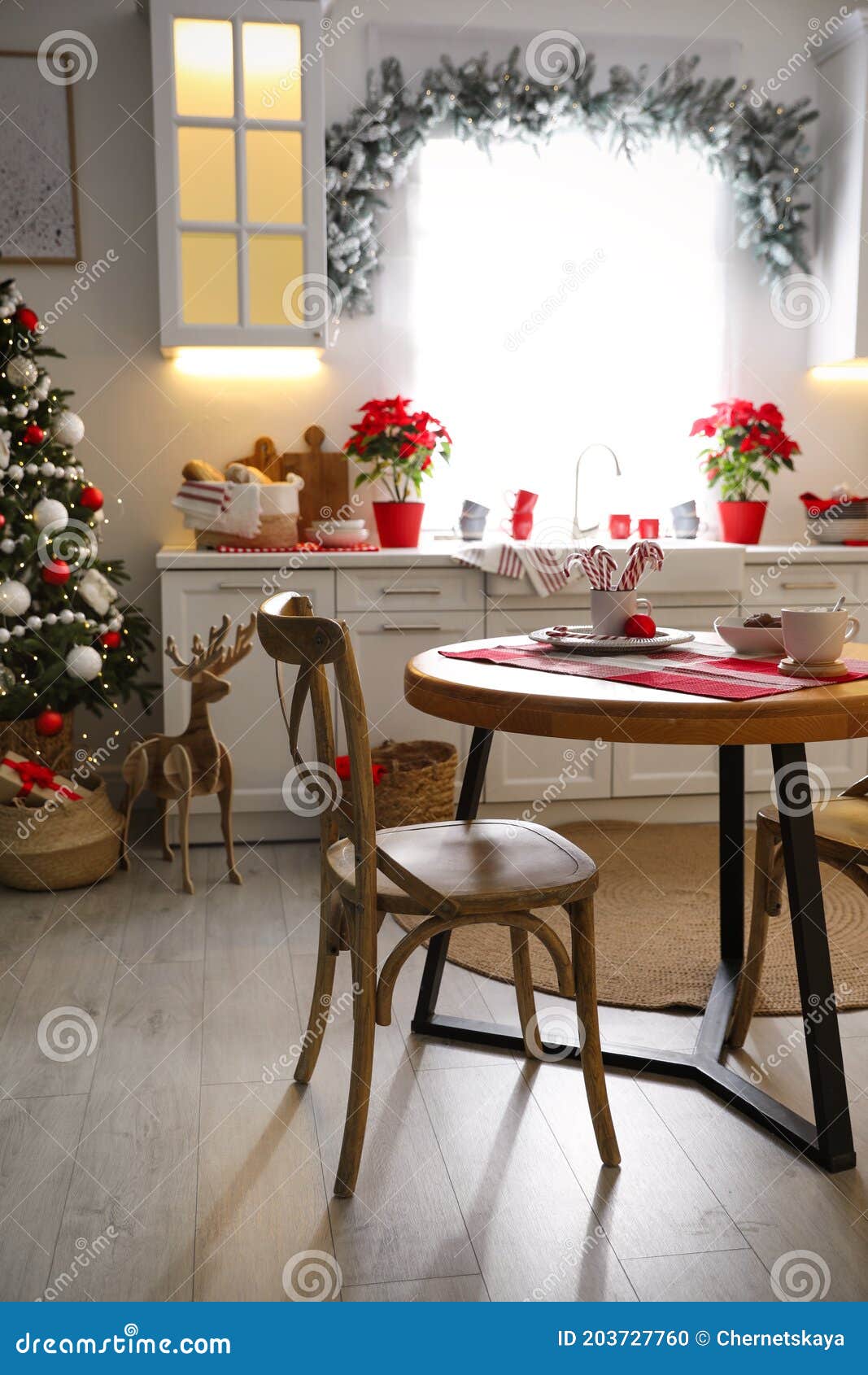 Beautiful Kitchen Interior with Christmas Tree and Festive Decor Stock