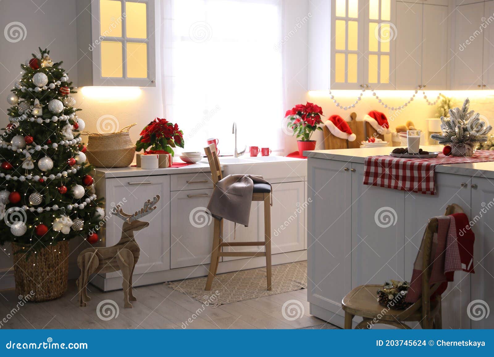 Beautiful Kitchen Interior with Christmas Tree and Festive Decor Stock
