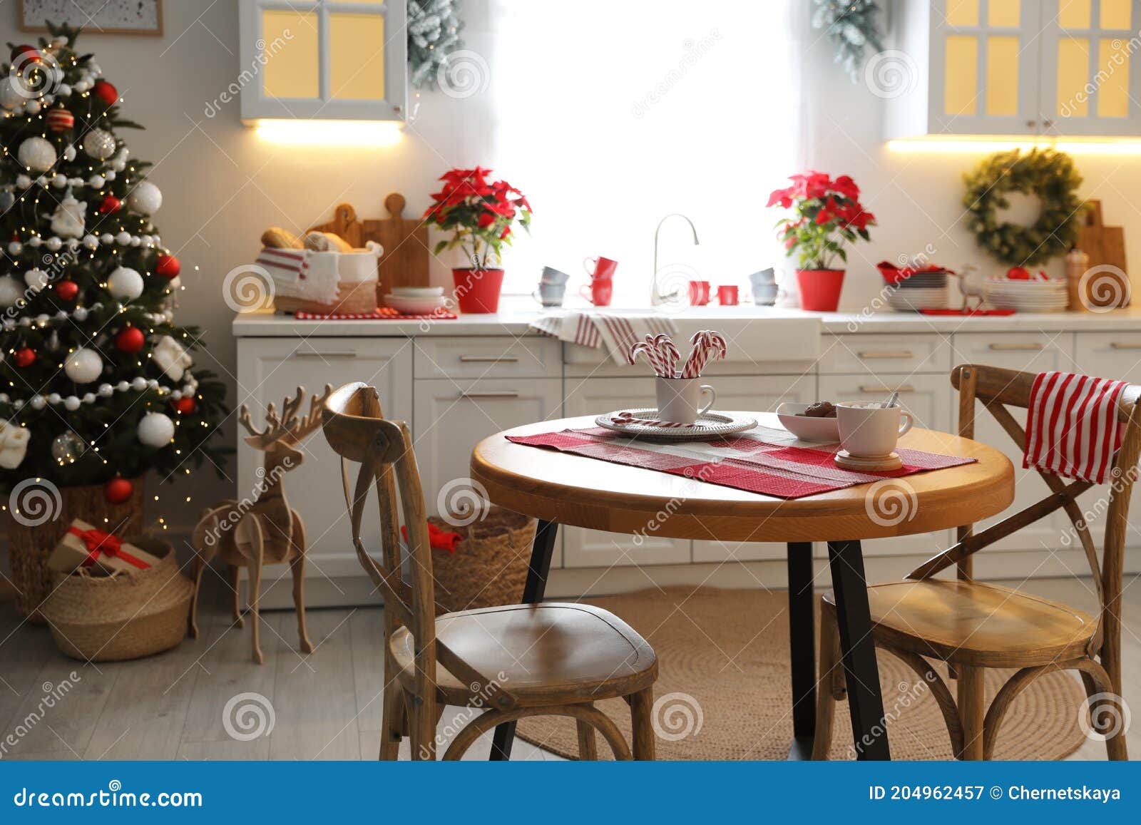 Beautiful Kitchen Interior with Christmas Tree and Festive Decor Stock