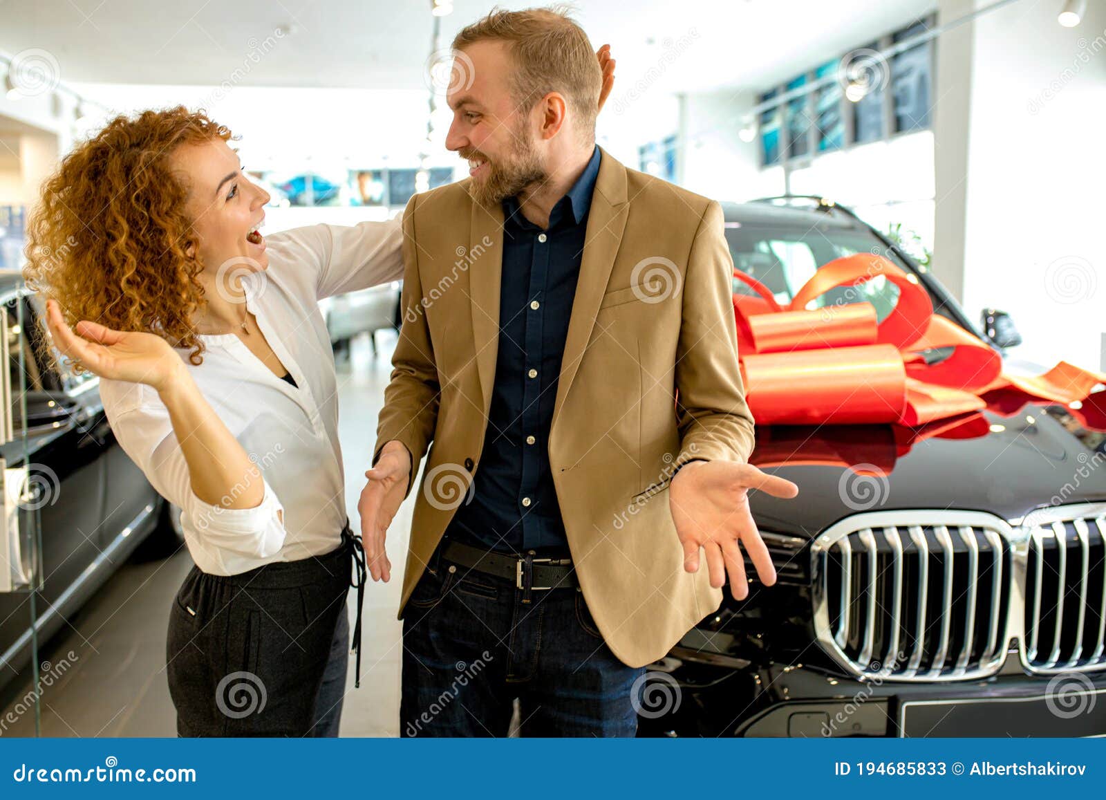 beautiful lady make surprise to husband in dealership