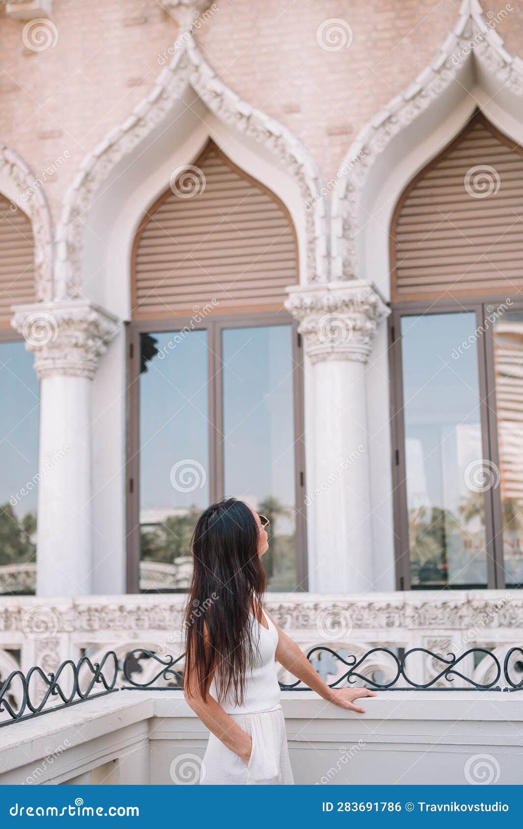 Beautiful lady watching the famous hotel in Las Vegas, standing in the busy  city. Famous tourist Stock Photo by travnikovstudio