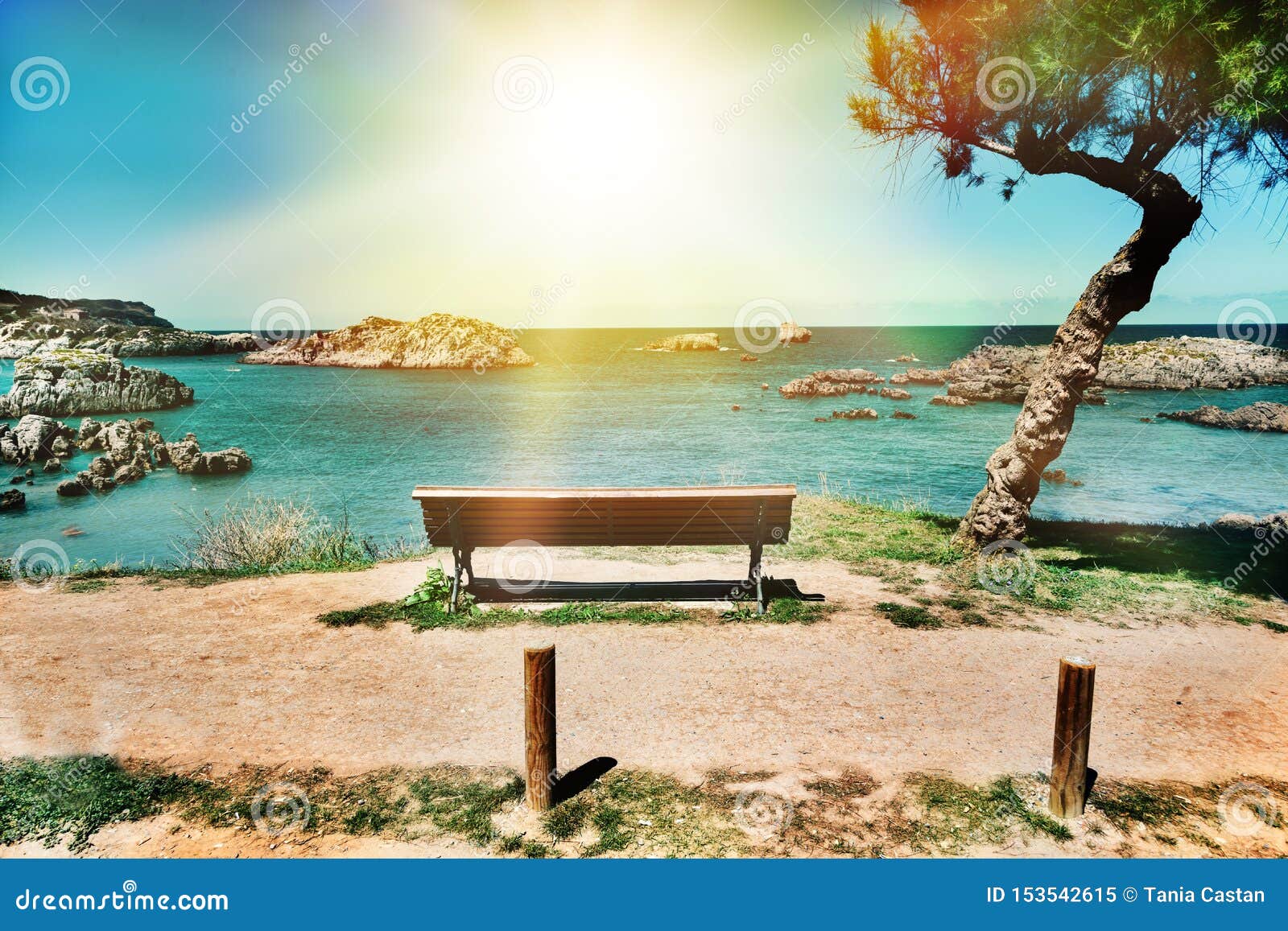 beautiful landscape of beach and coast with mountains and vegetation. lonely bench on a cliff facing the sea cantabria, spain.