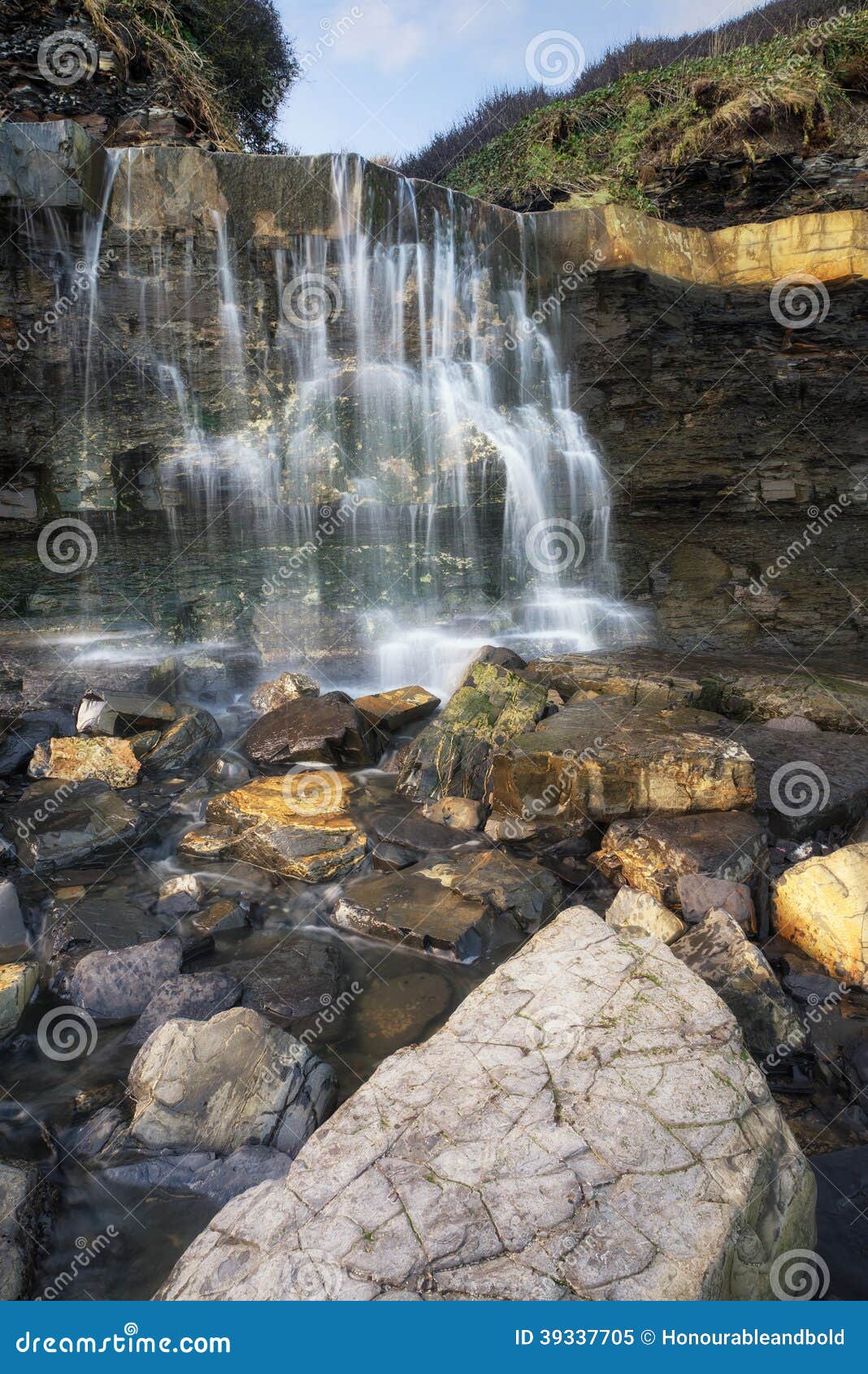 Beautiful Landscape Image Waterfall Flowing Into Rocks On Beach Stock