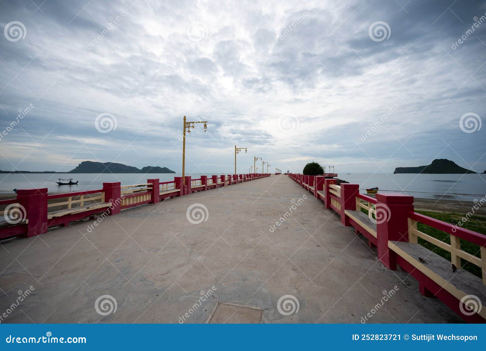 beautiful landscape long red pier or a bridge named saranwithi bridge to the sea with cloud at ao prachuap bay prachuap khiri khan