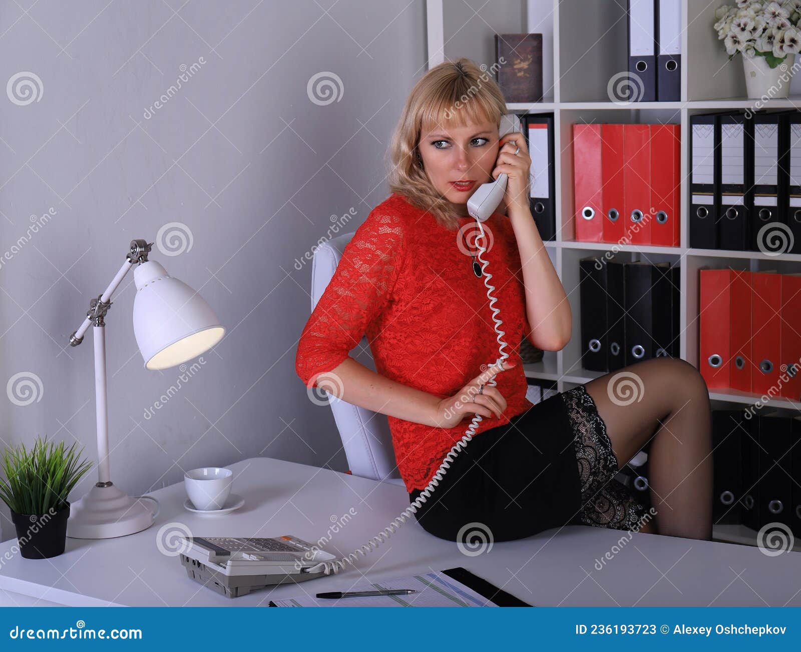Beautiful Legged Blonde Girl In Black Stockings And Black Minidress Posing On Table Stock Image