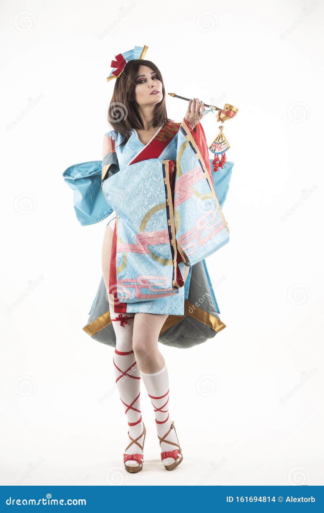 Beautiful Leggy Busty Cosplayer Girl Wearing a Stylized Japanese Kimono  Costume Cheerfully Posing Holding a Fake Pipe in the Wind Stock Photo -  Image of eyes, dress: 161694814
