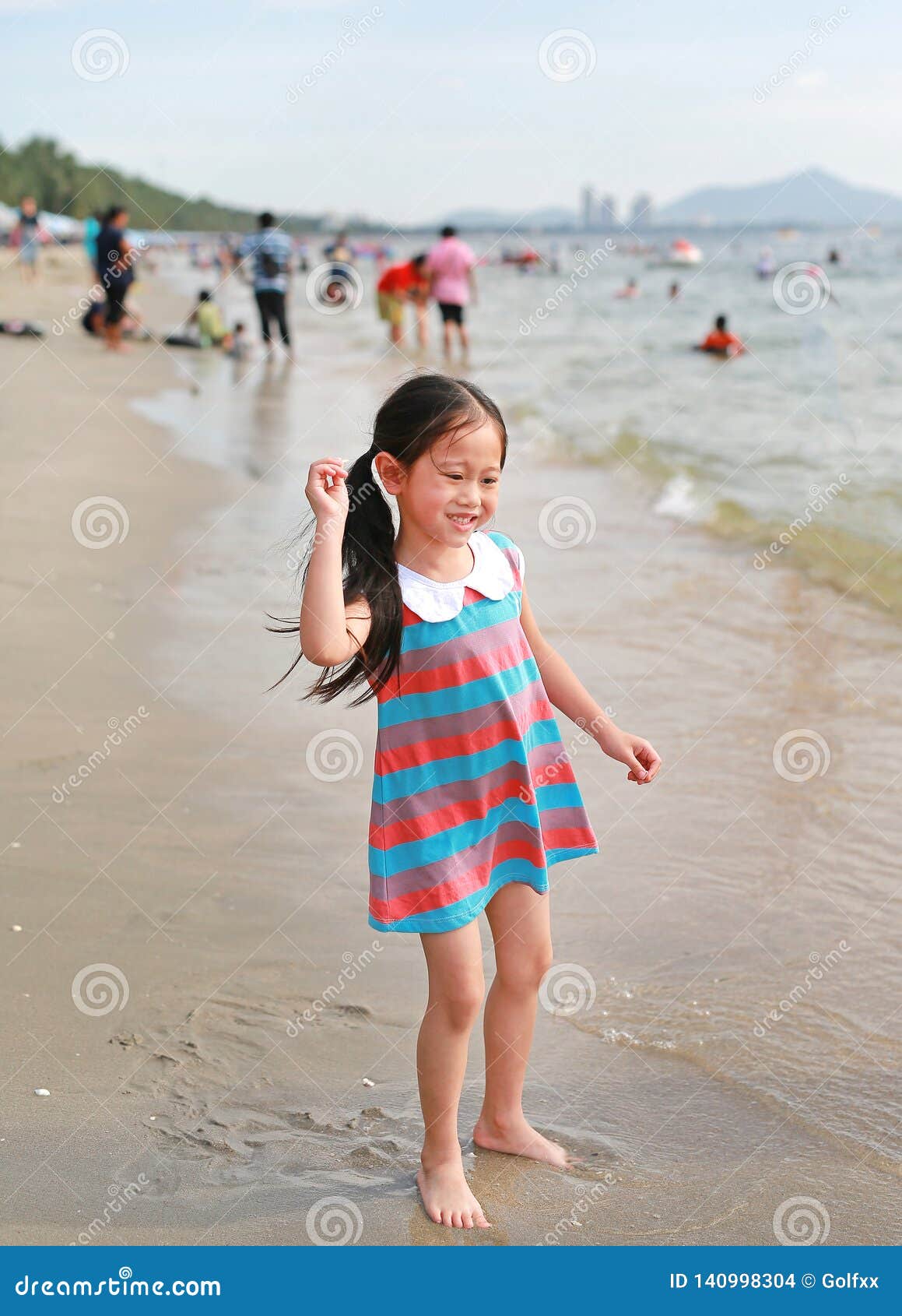 Chinese Little Girl At The Beach Stock Photo - Download 