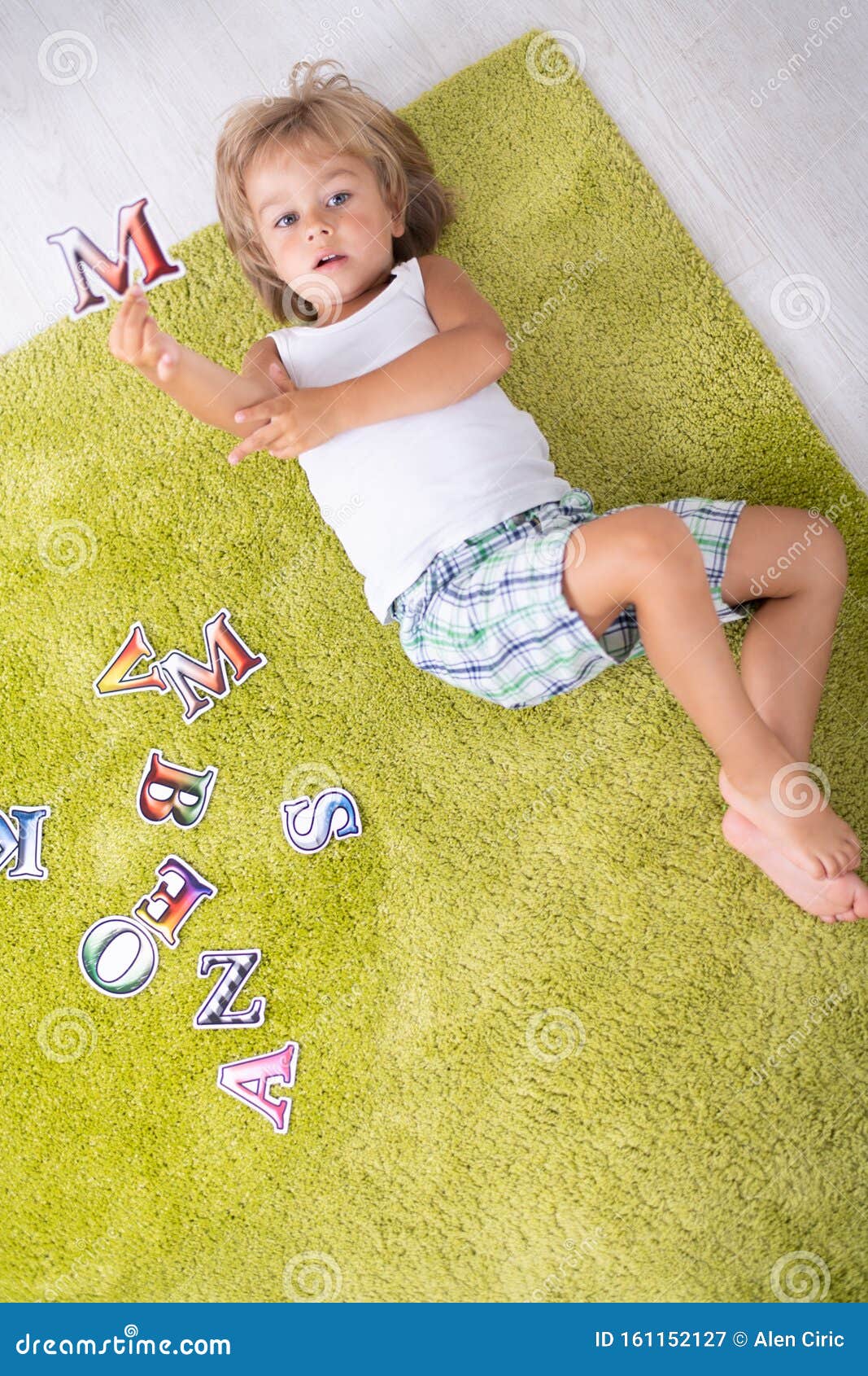 Beautiful Little Boy Laying Down On The Floor And Learning Letters At Home. Top View Stock Image