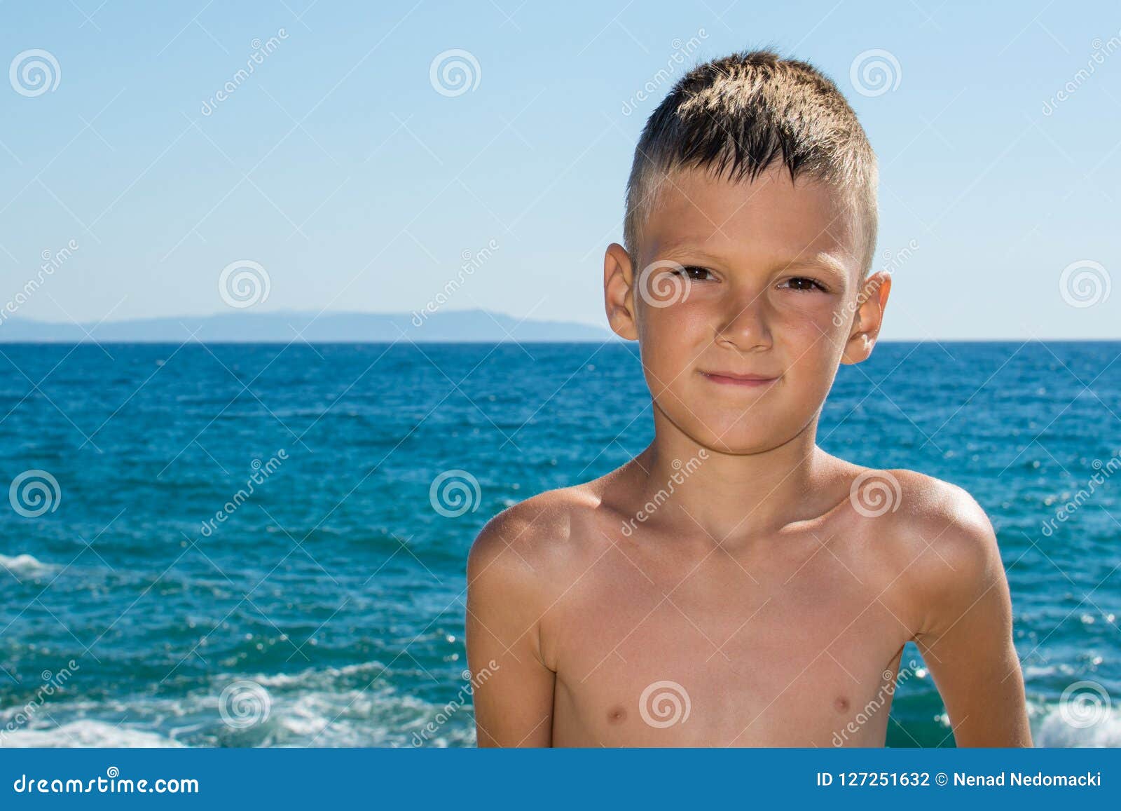 A Beautiful Little Boy Posing on a Beach by the Sea Stock Photo - Image ...