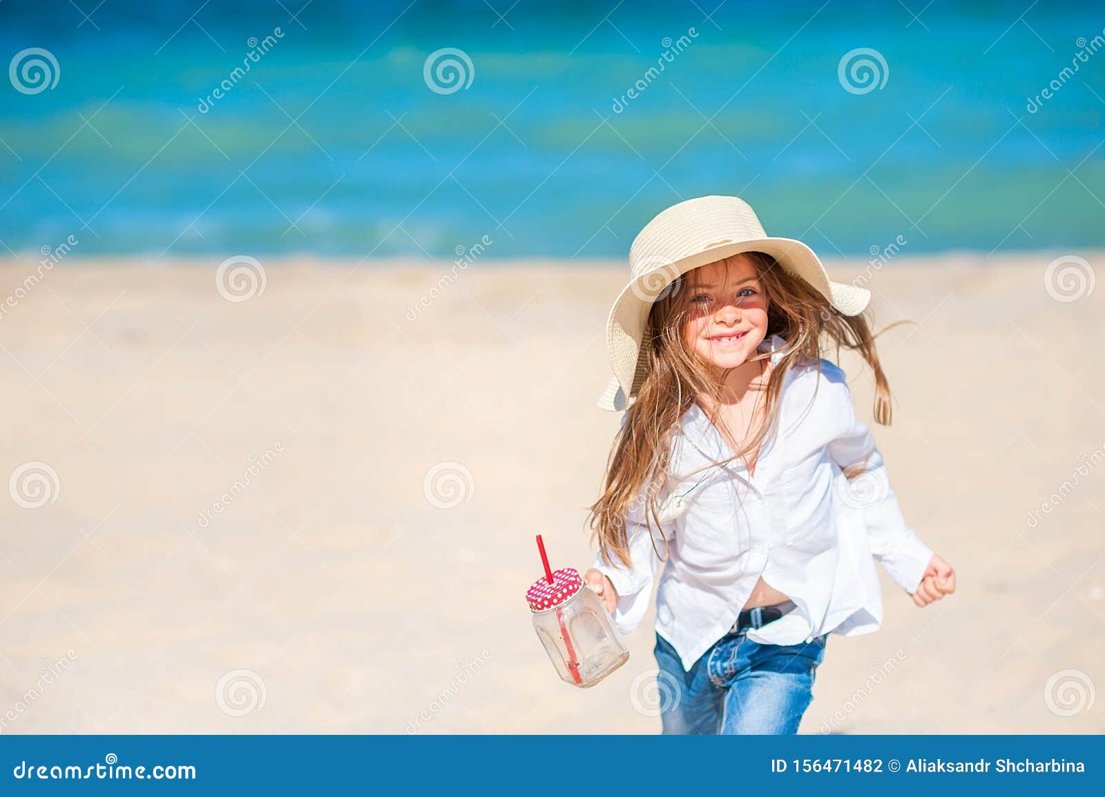 Beautiful Little Girl in a Beach Hat Playing and Having Fun Stock Photo ...