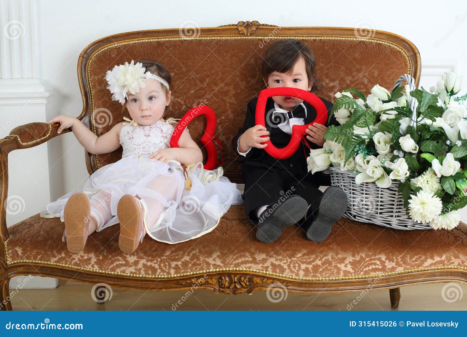 beautiful little kids in costumes bride and groom