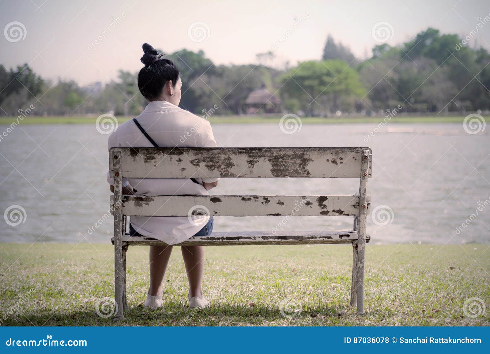 beautiful lonely woman in frustrated depression sitting alone on