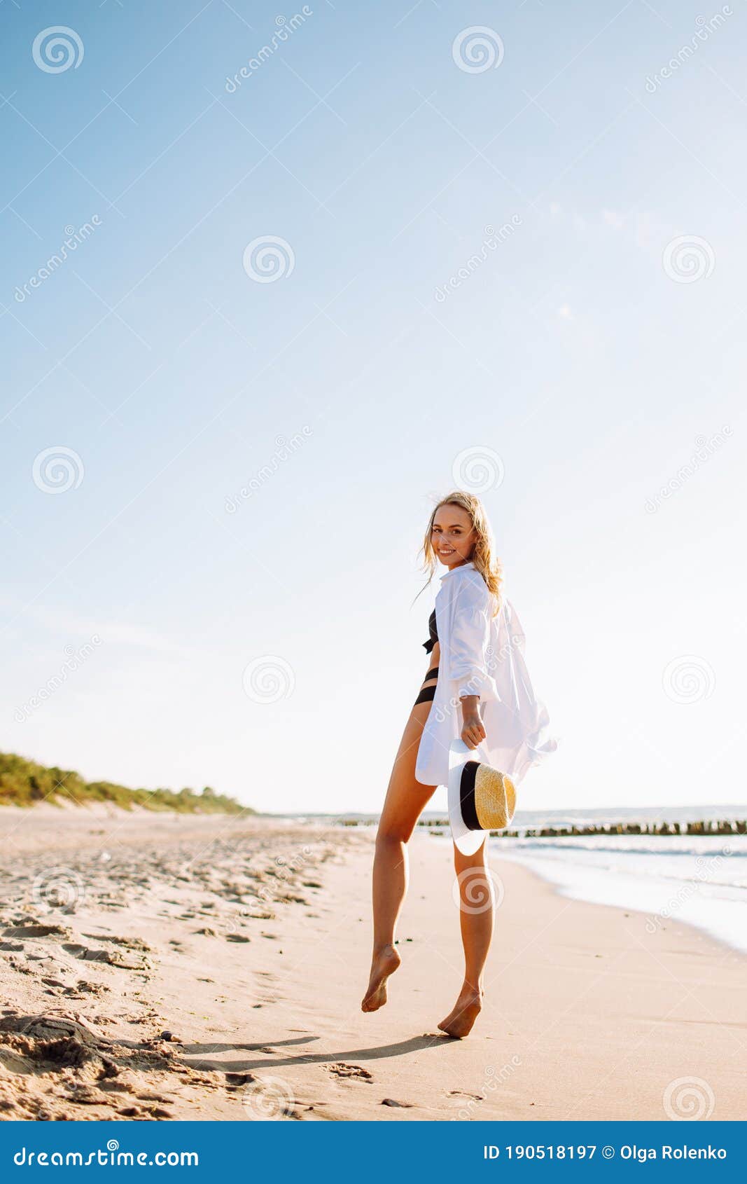 Beautiful Luxury Slim Girl In A Black Bikini And White Shirt On The