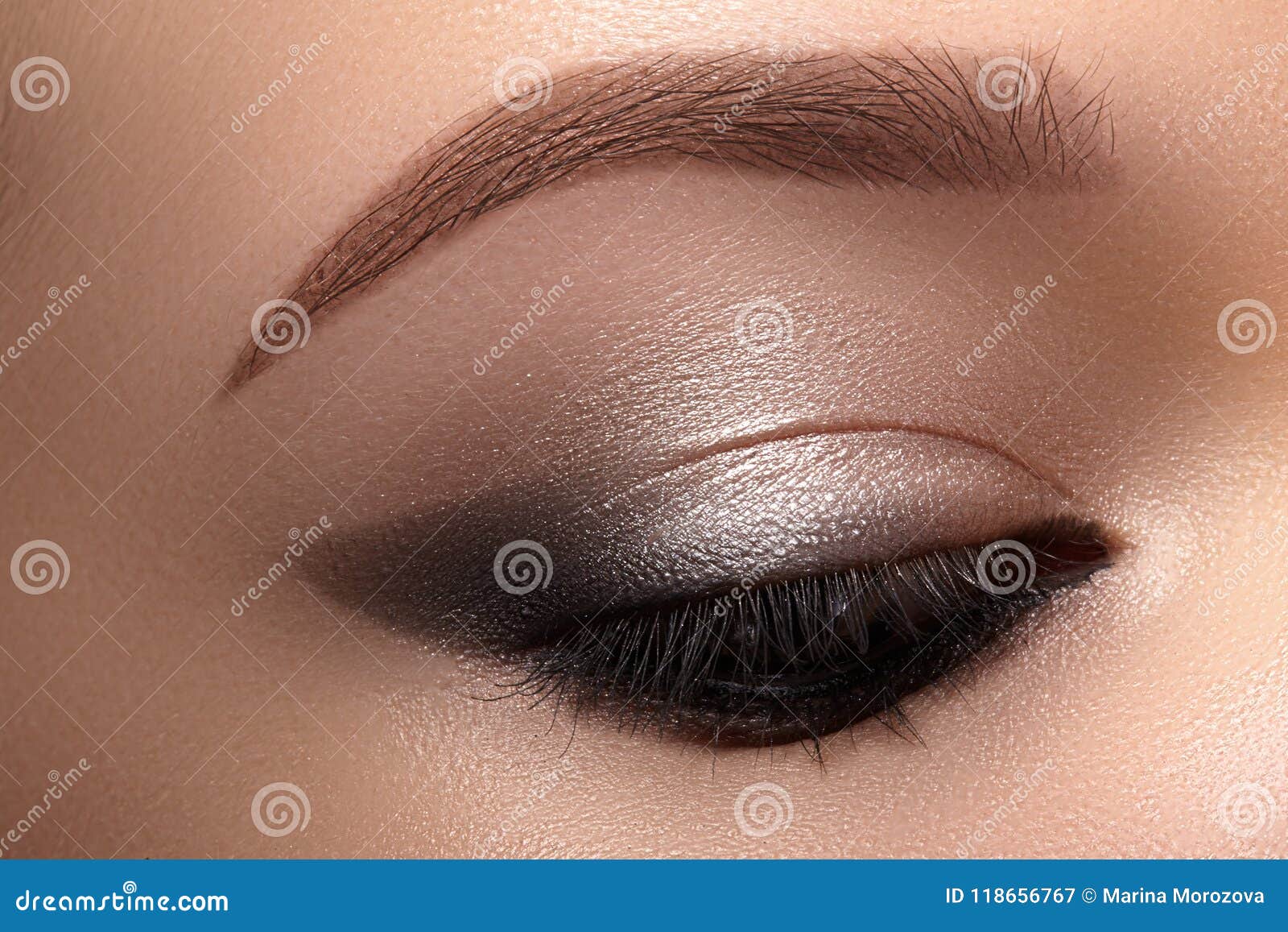 beautiful macro eyes with smoky cat eye makeup. cosmetics and make-up. closeup of fashion visage with liner, eyeshadows
