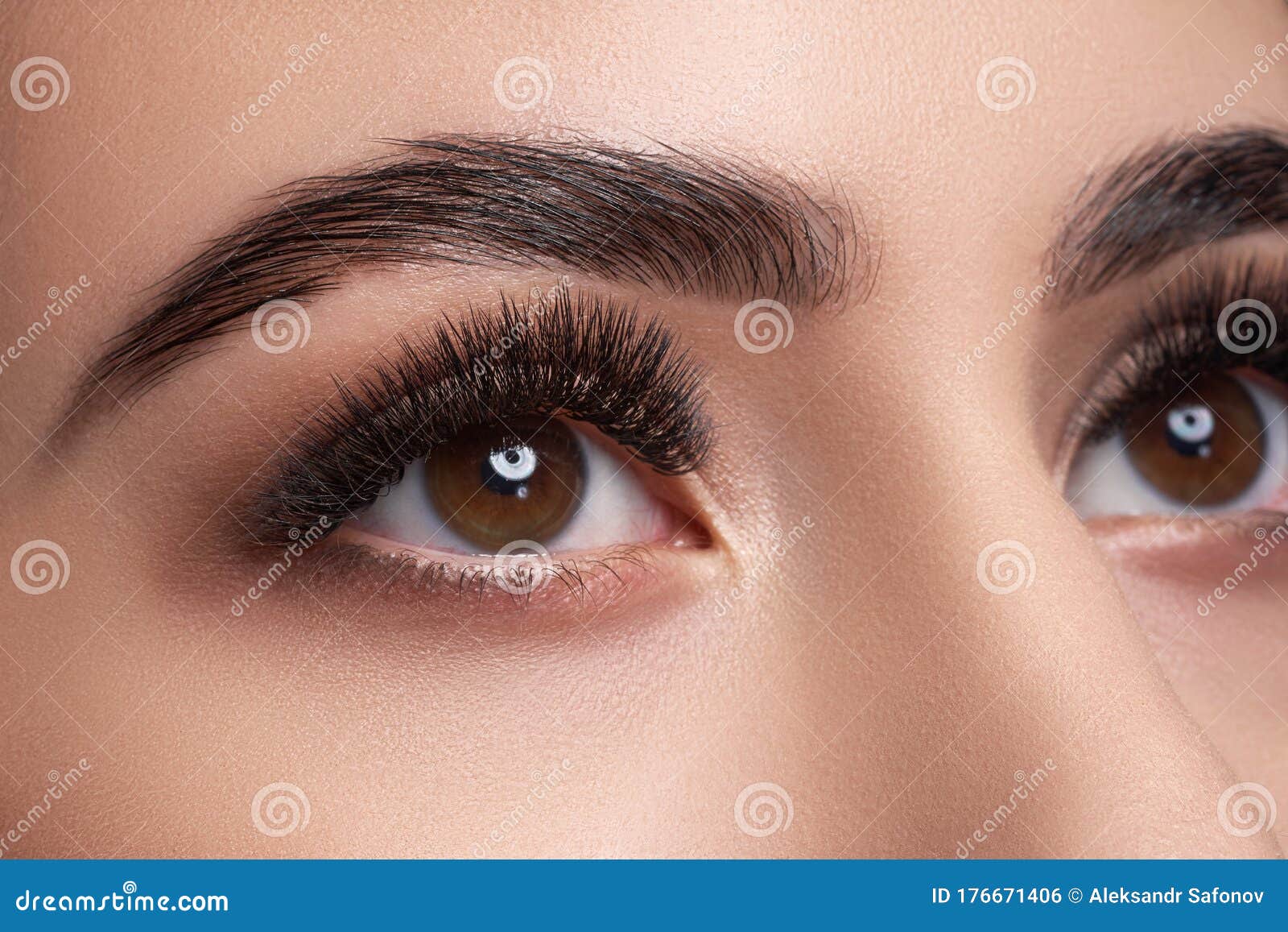 beautiful macro photography of a woman`s eye with extreme makeup of long lashes