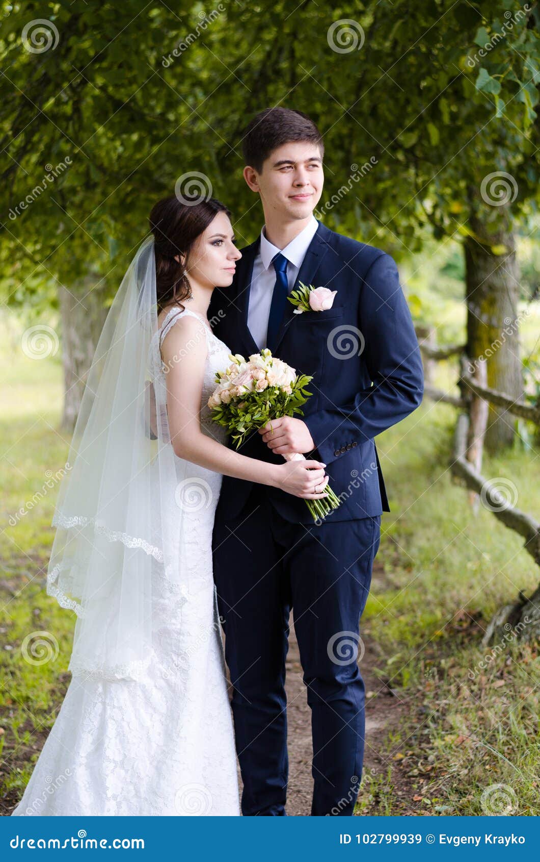 A Beautiful Married Couple in Wedding Dresses, Posing for a Photo Shooting  in an Belarusian Village Near the Fence, with a Wedding Stock Image - Image  of female, bride: 102799939