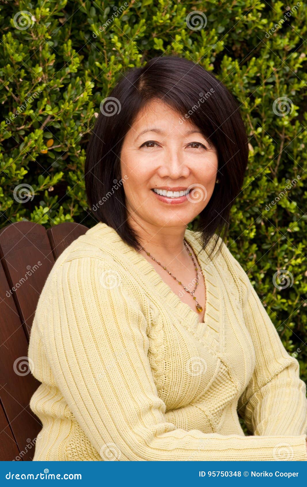 Beautiful Mature Asian Woman Sitting Outside. Stock Photo Image of