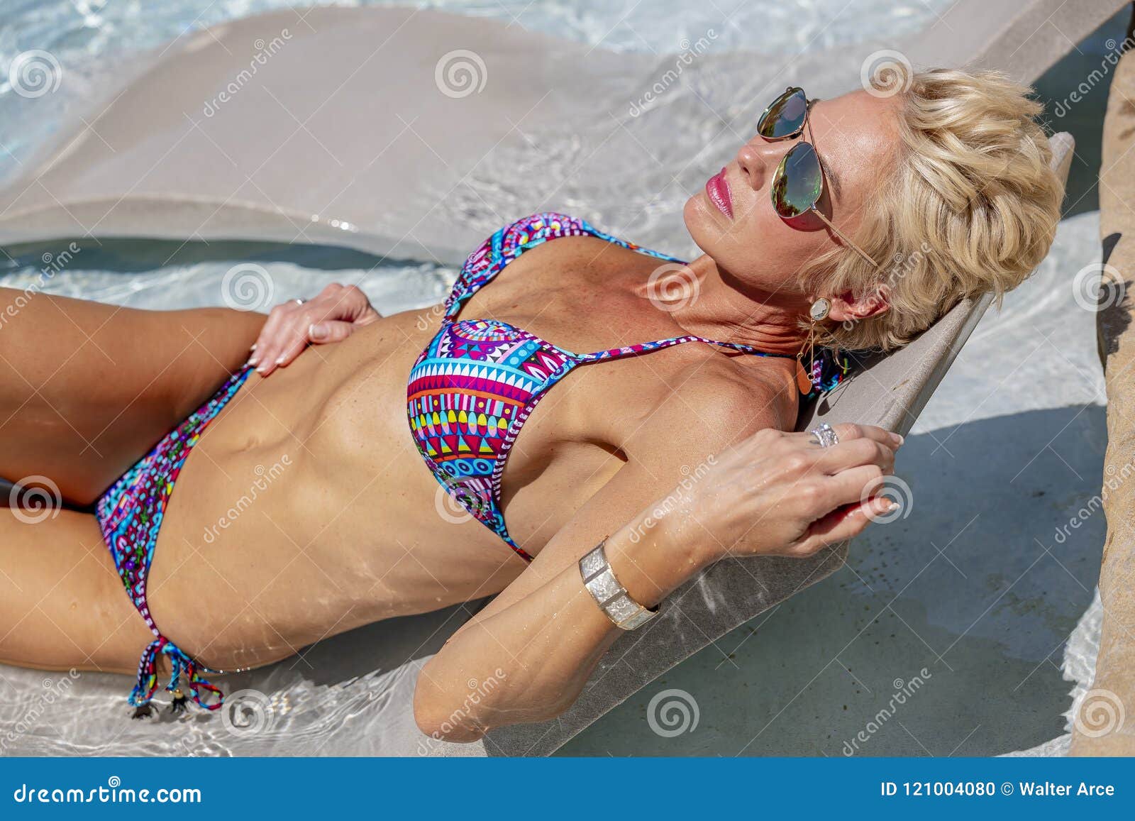 Gorgeous Blonde Model Posing Outdoors Near a Swimming Pool Stock Photo