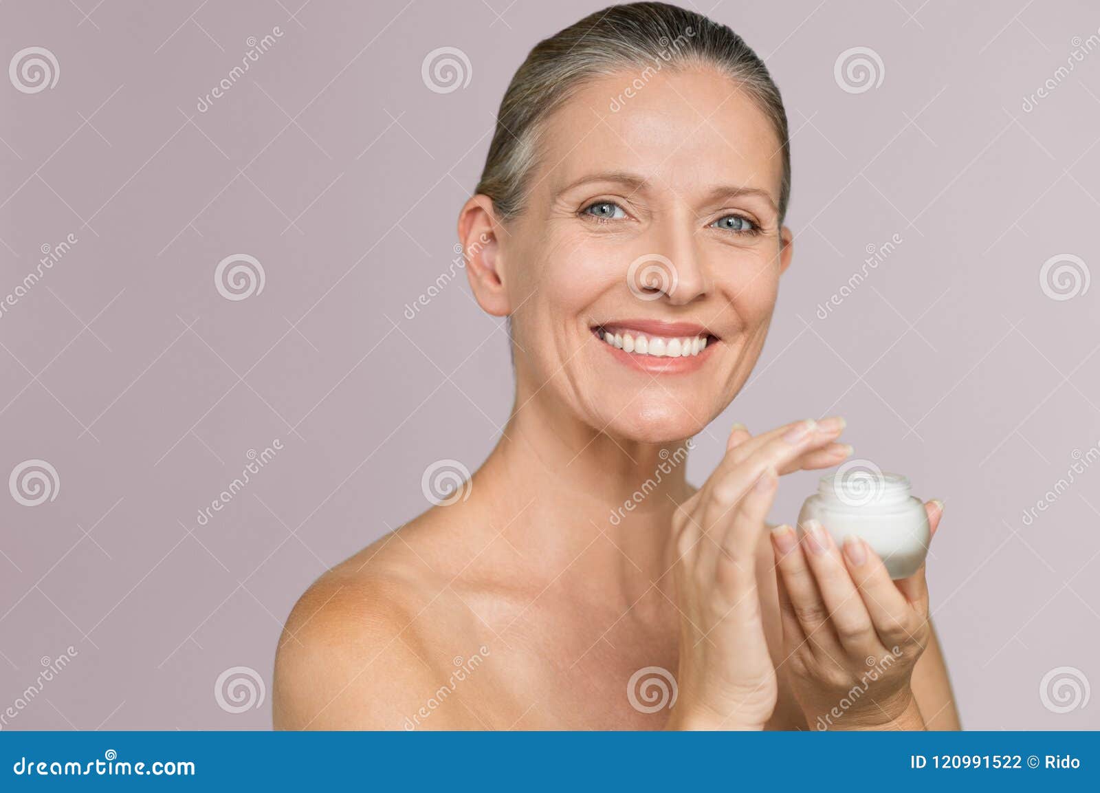 woman holding jar of moisturizer