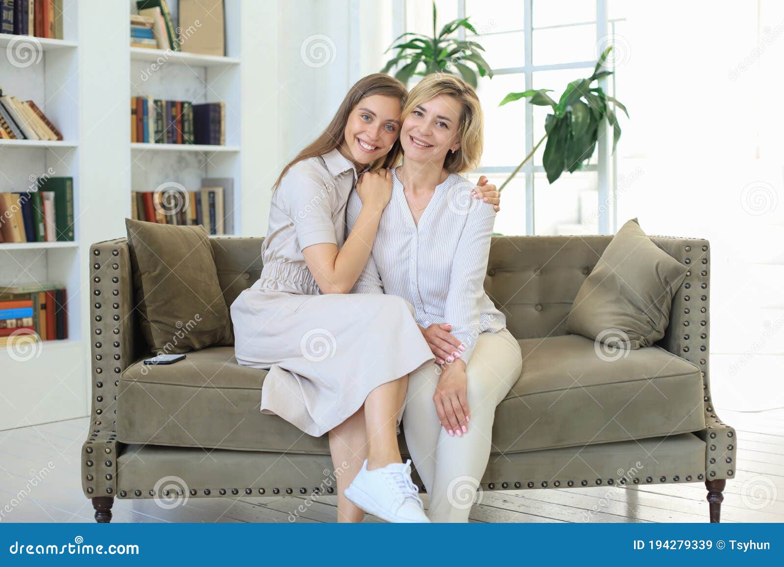 Beautiful Middle Aged Mom And Her Adult Daughter Are Hugging Looking 