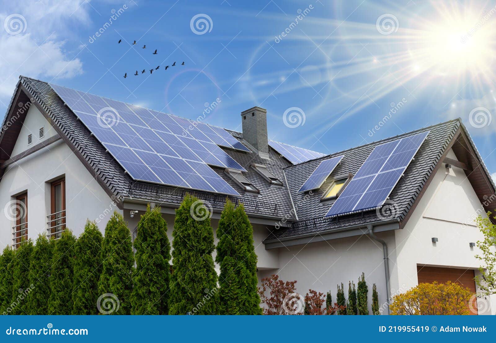 beautiful modern house with solar panels. clear sky, sun