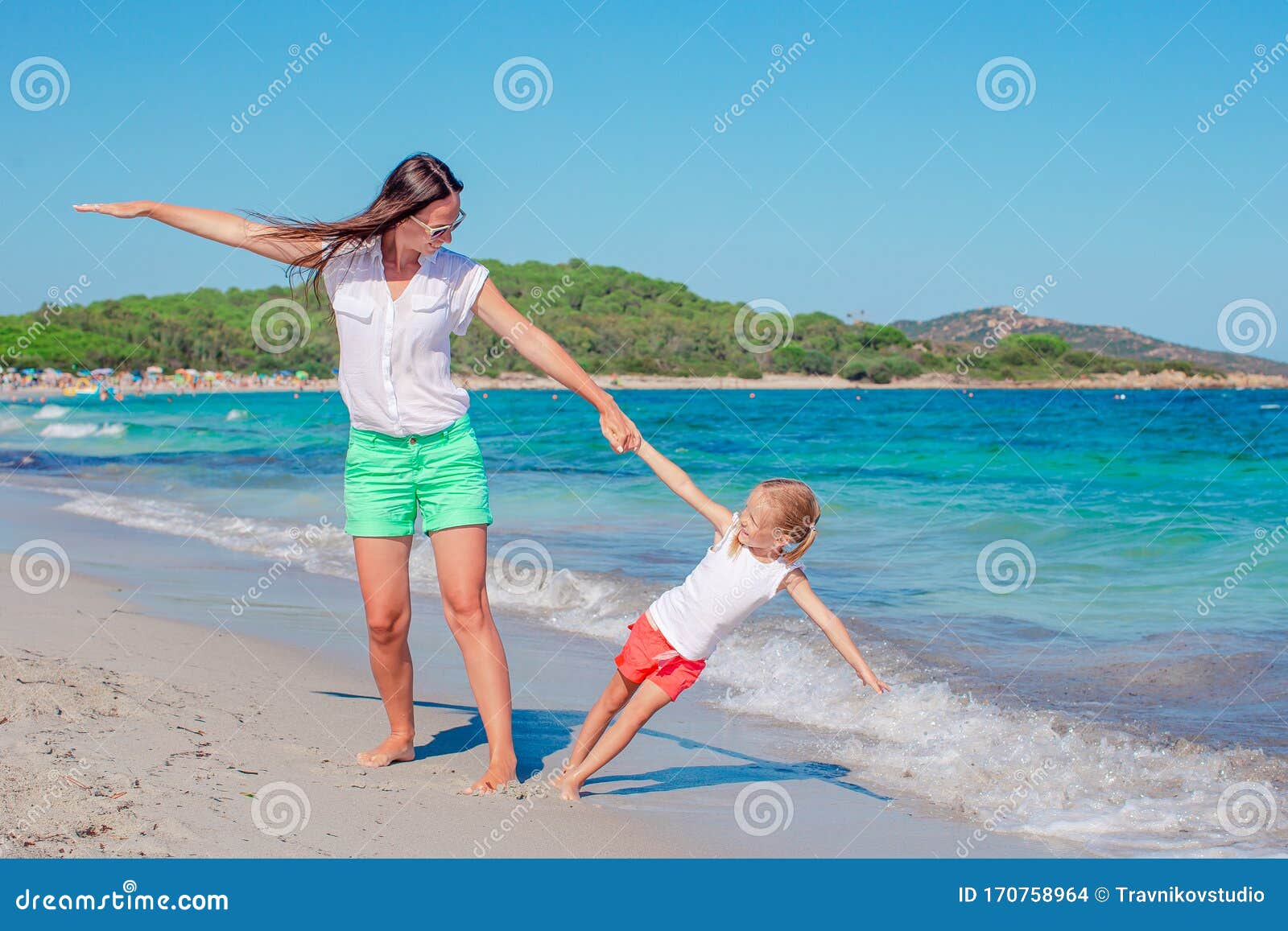 Beautiful Mother And Daughter At The Beach Enjoying Summer Vacation 