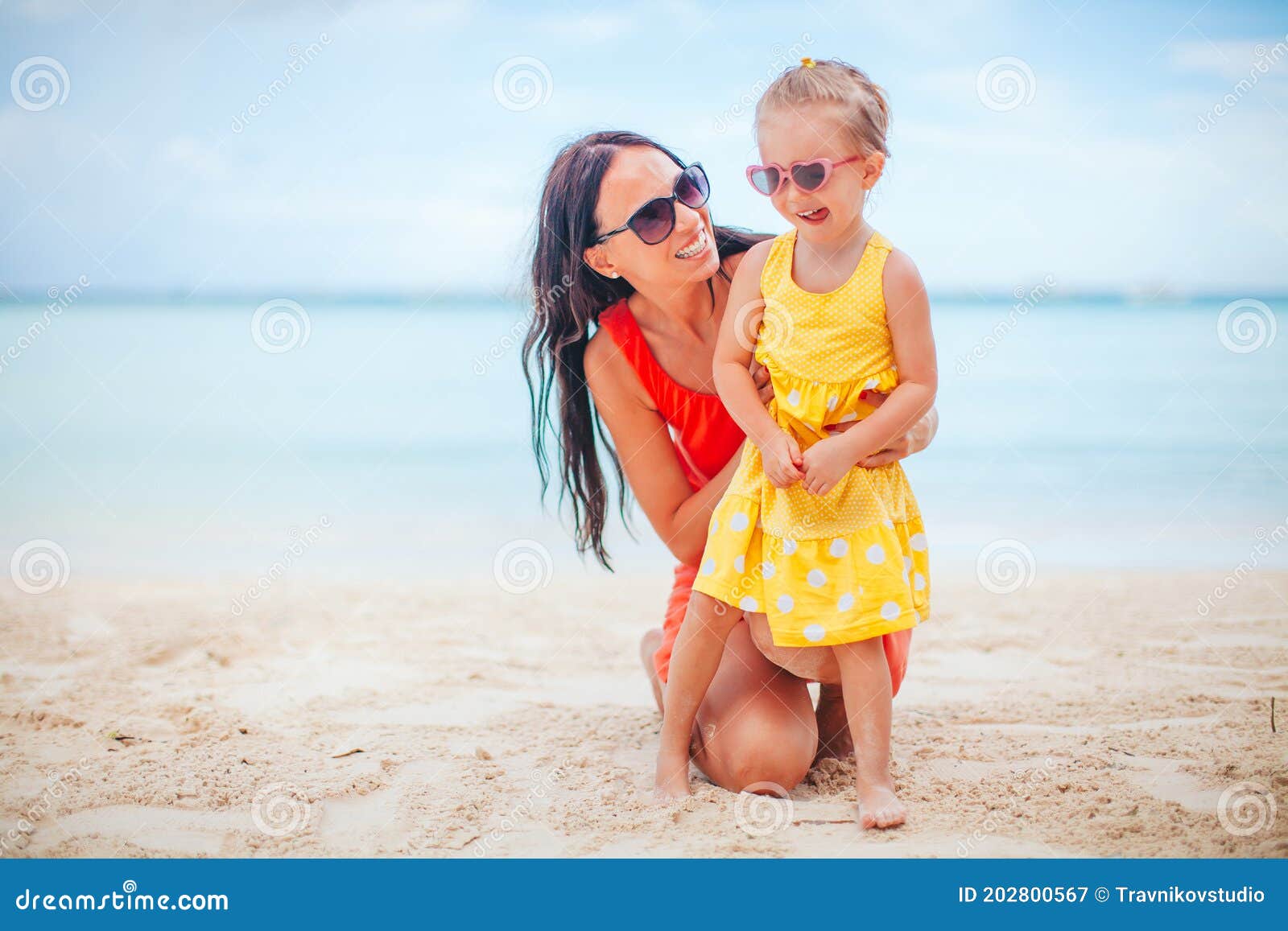 Beautiful Mother And Daughter At The Beach Enjoying Summer Vacation 