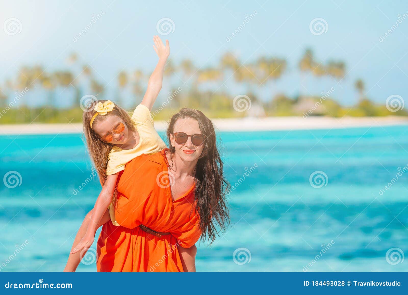 Beautiful Mother And Daughter At Caribbean Beach Enjoying Summer 