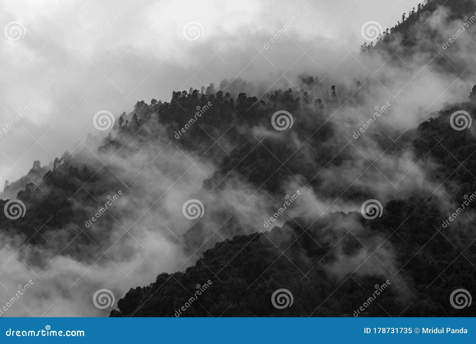 a beautiful mountain view with fog and clouds