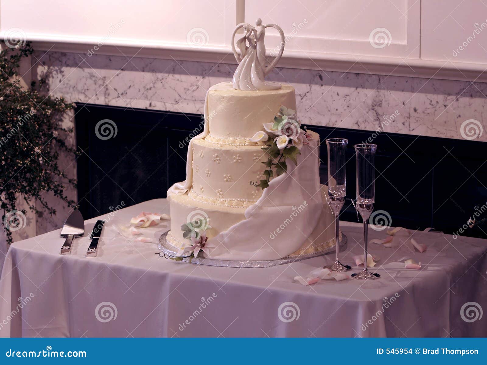 Beautiful MultiTier Wedding Cake and Champagne Glasses Stock Photo