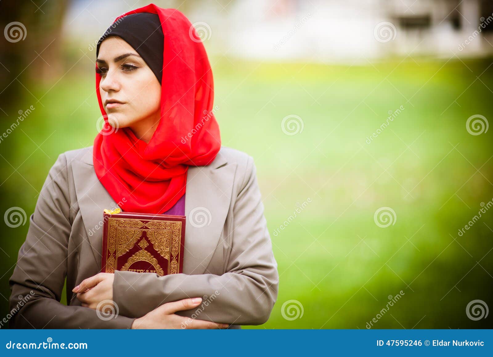 Beautiful Muslim Woman Wearing Hijab And Holding A Holy 