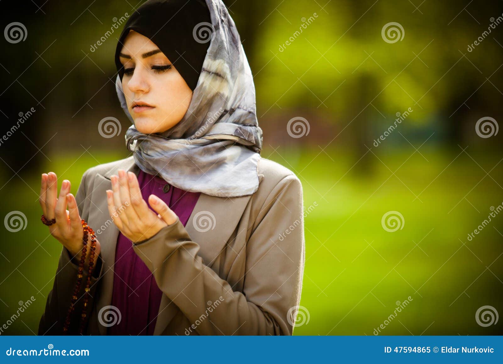 .Beautiful Muslim Woman Wearing Hijab Praying On Rosary 