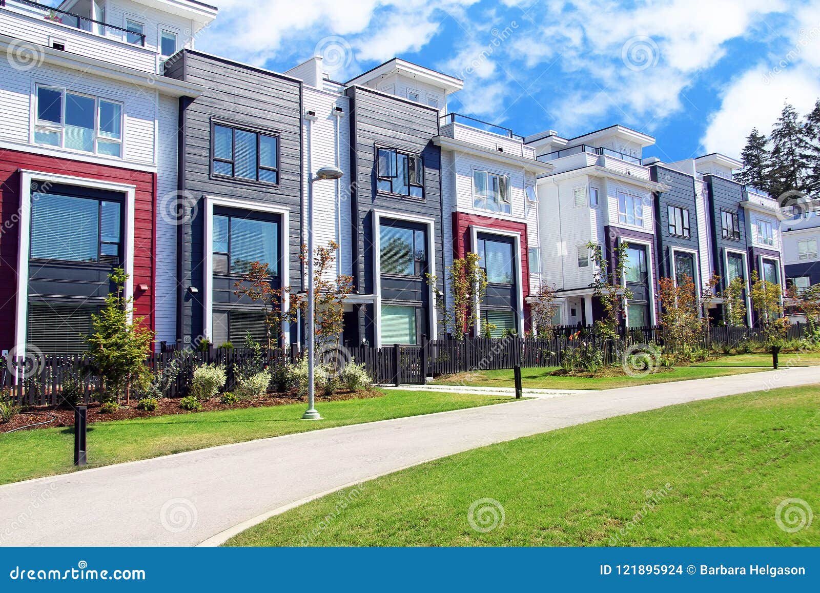 Beautiful new contempory suburban attached townhomes with colorful summer gardens in a Canadian neighborhood.