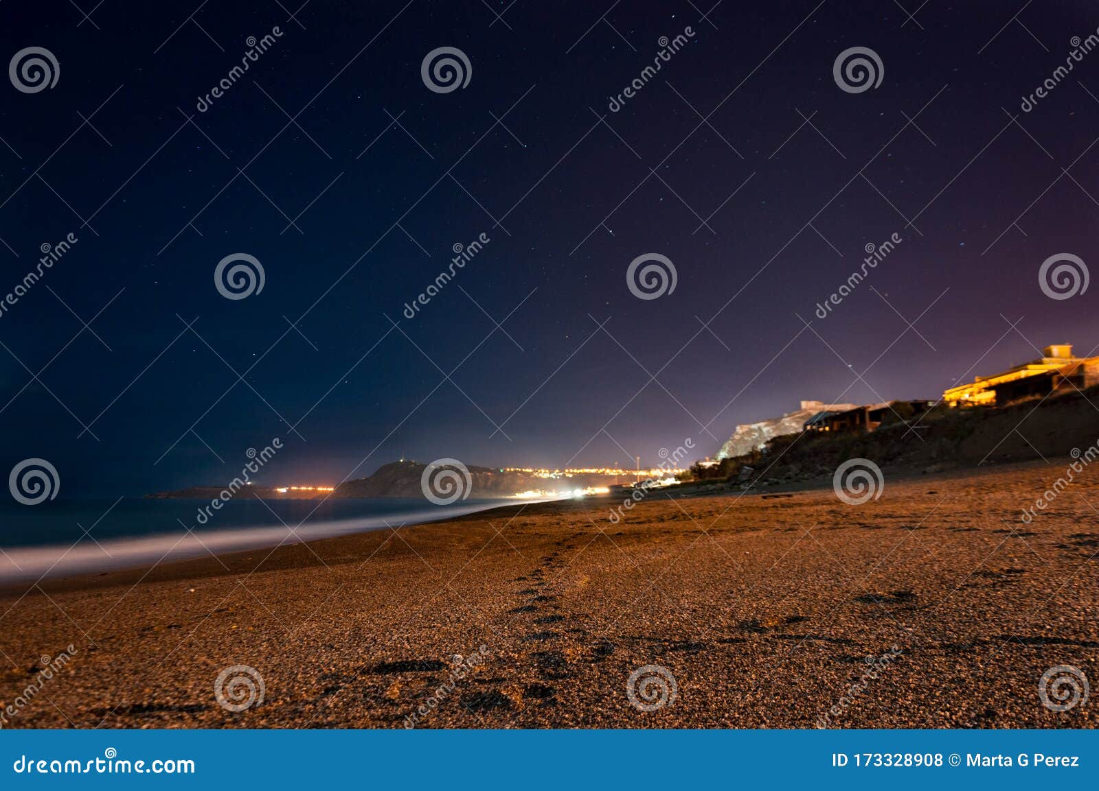 a beautiful night on baia del tono or tono`s bay. long exposition with a selective focus on the footprints 