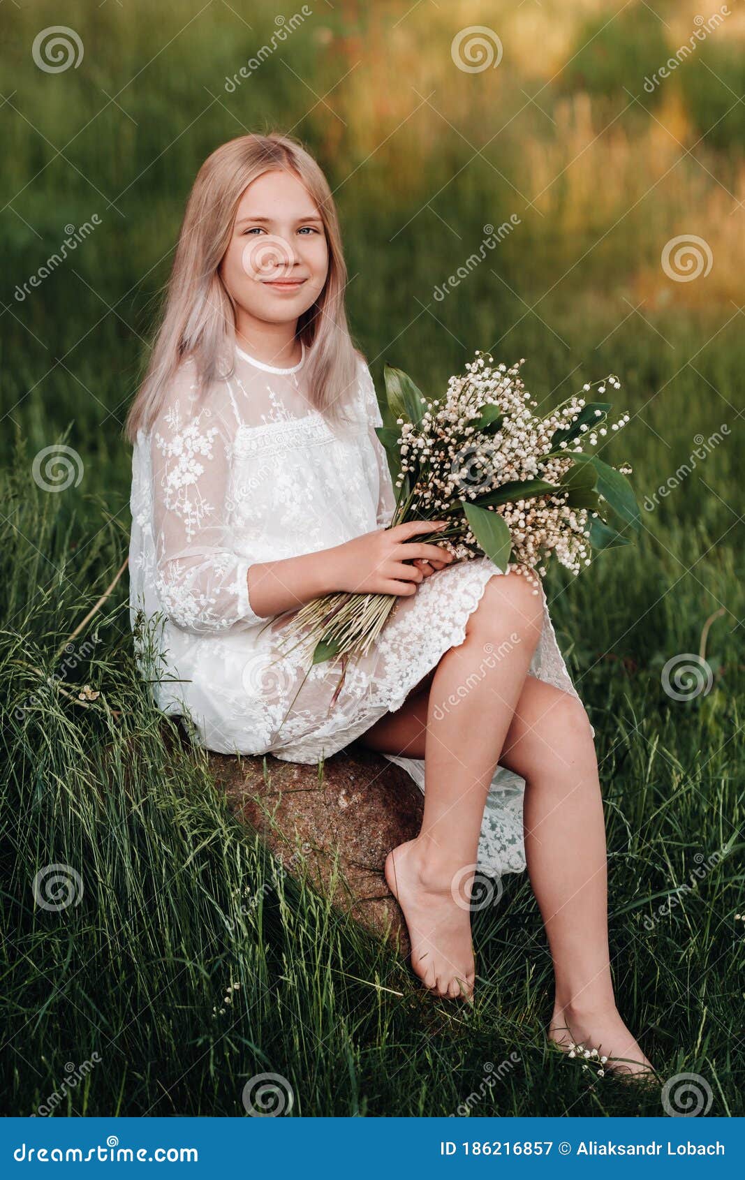 A Beautiful Nine-year-old Blonde Girl with Long Hair in a Long White ...