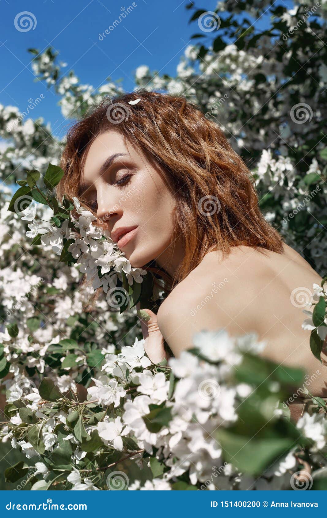 Beautiful Nude Art Woman In Branches And Foliage Of A Flowering Apple