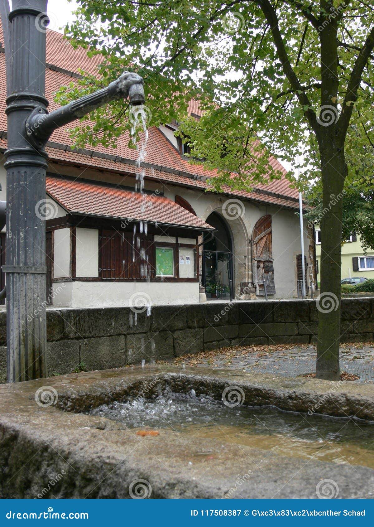 large half-timbered house behind a fountain