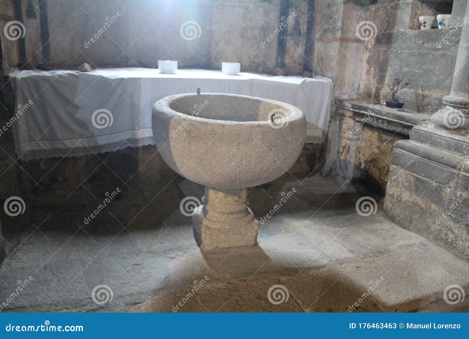 beautiful old stone baptismal font where it is converted to christianity