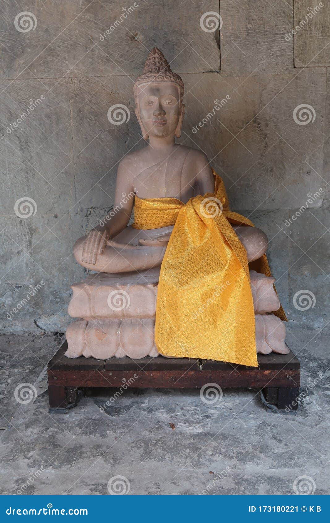 beautiful stone statue of buddha with yellow scarf in ancient angkor wat temple, religous site for hindu and buddhism
