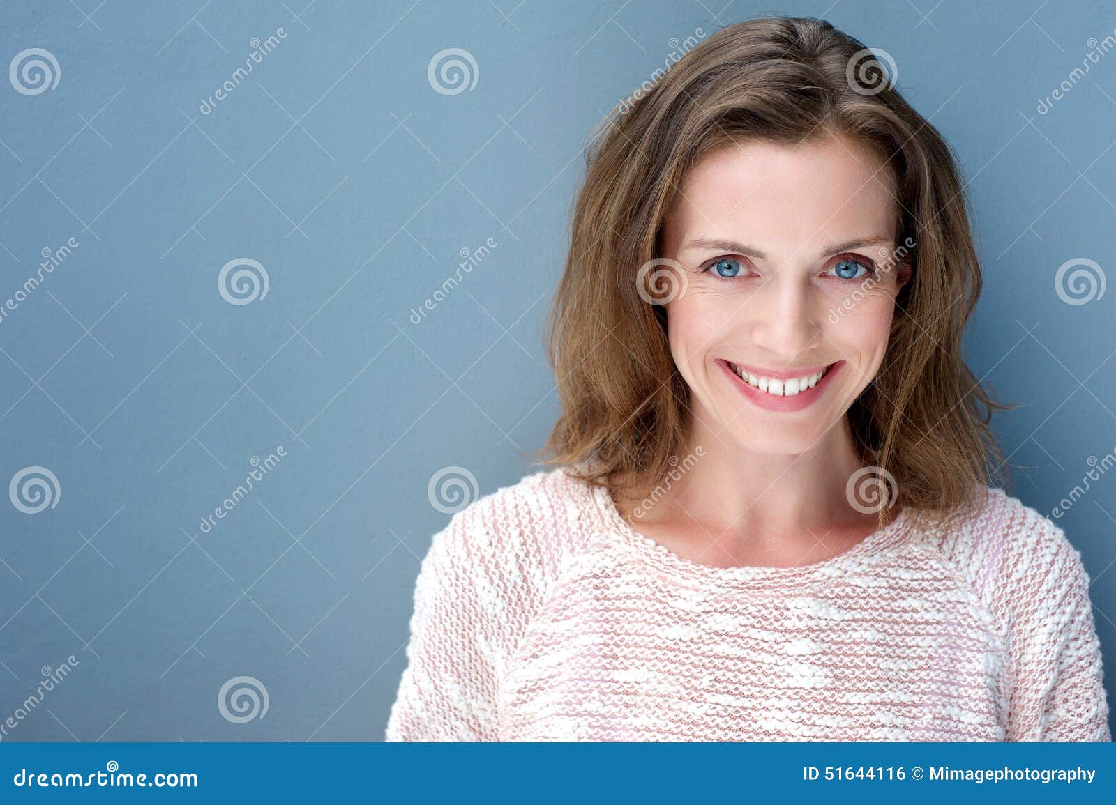 beautiful older woman smiling with sweater