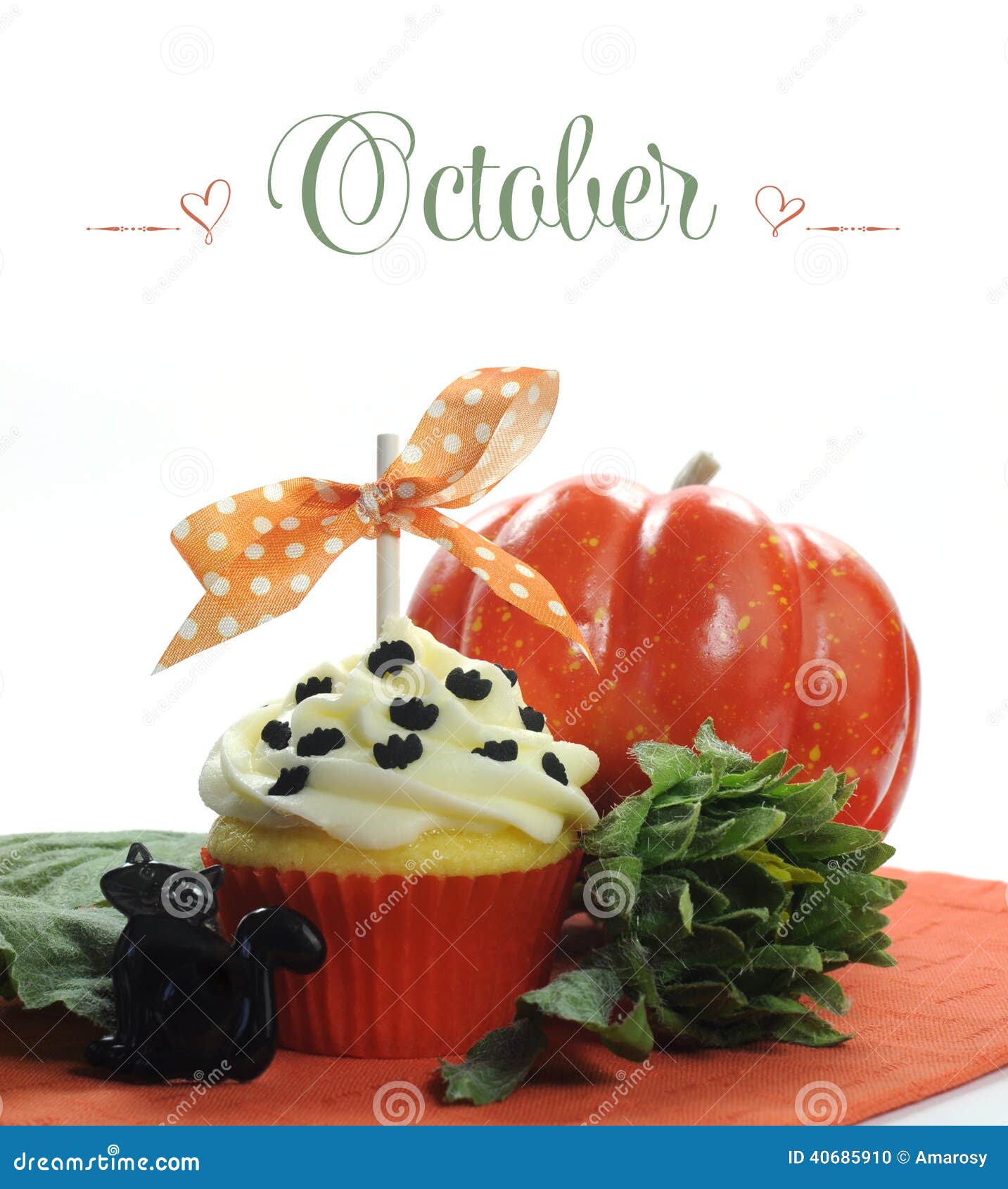 beautiful orange halloween theme cupcake with seasonal flowers and decorations for the month of october